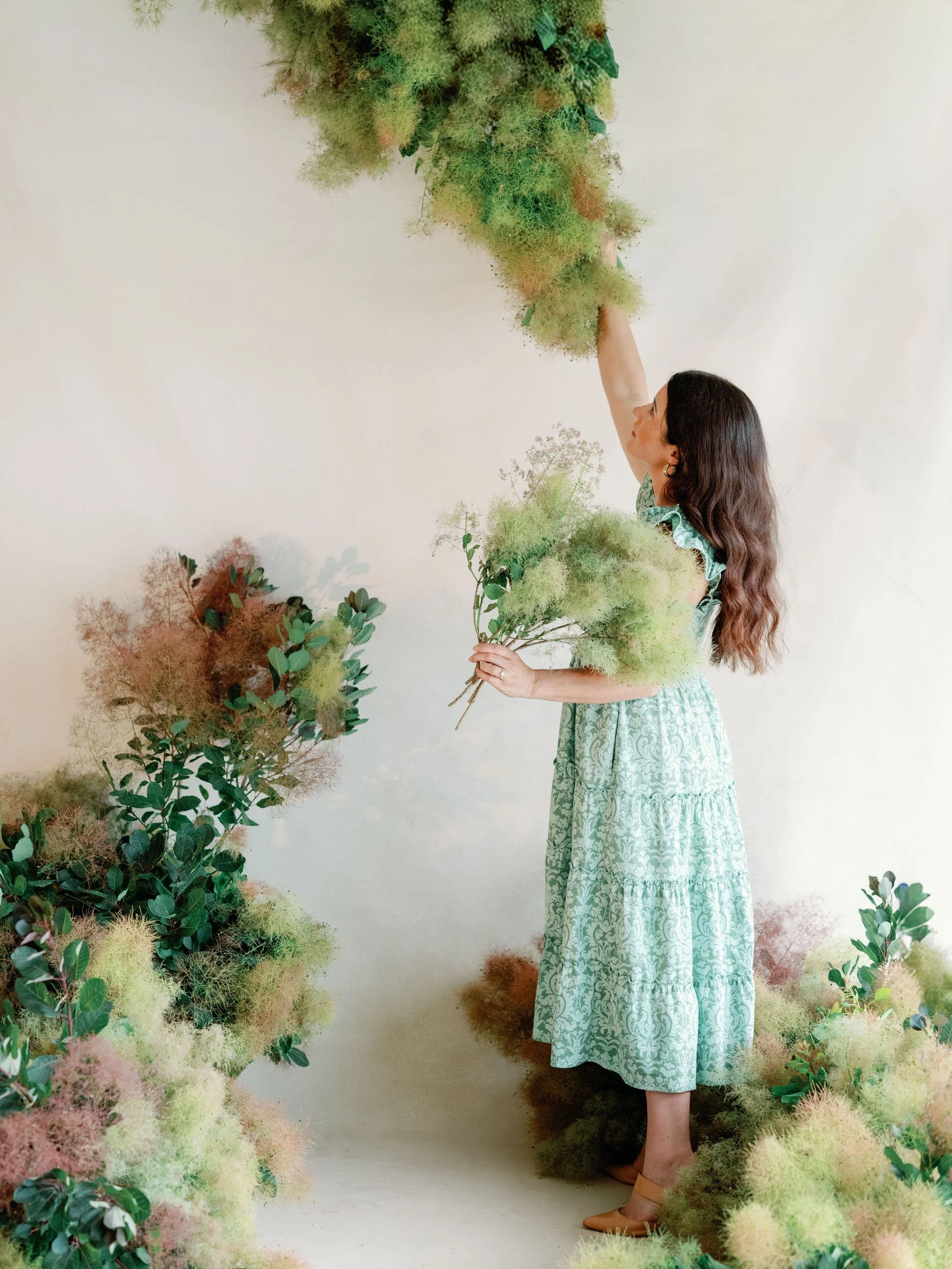rhiannon bosse, west michigan floral and wedding designer setting up floral installation