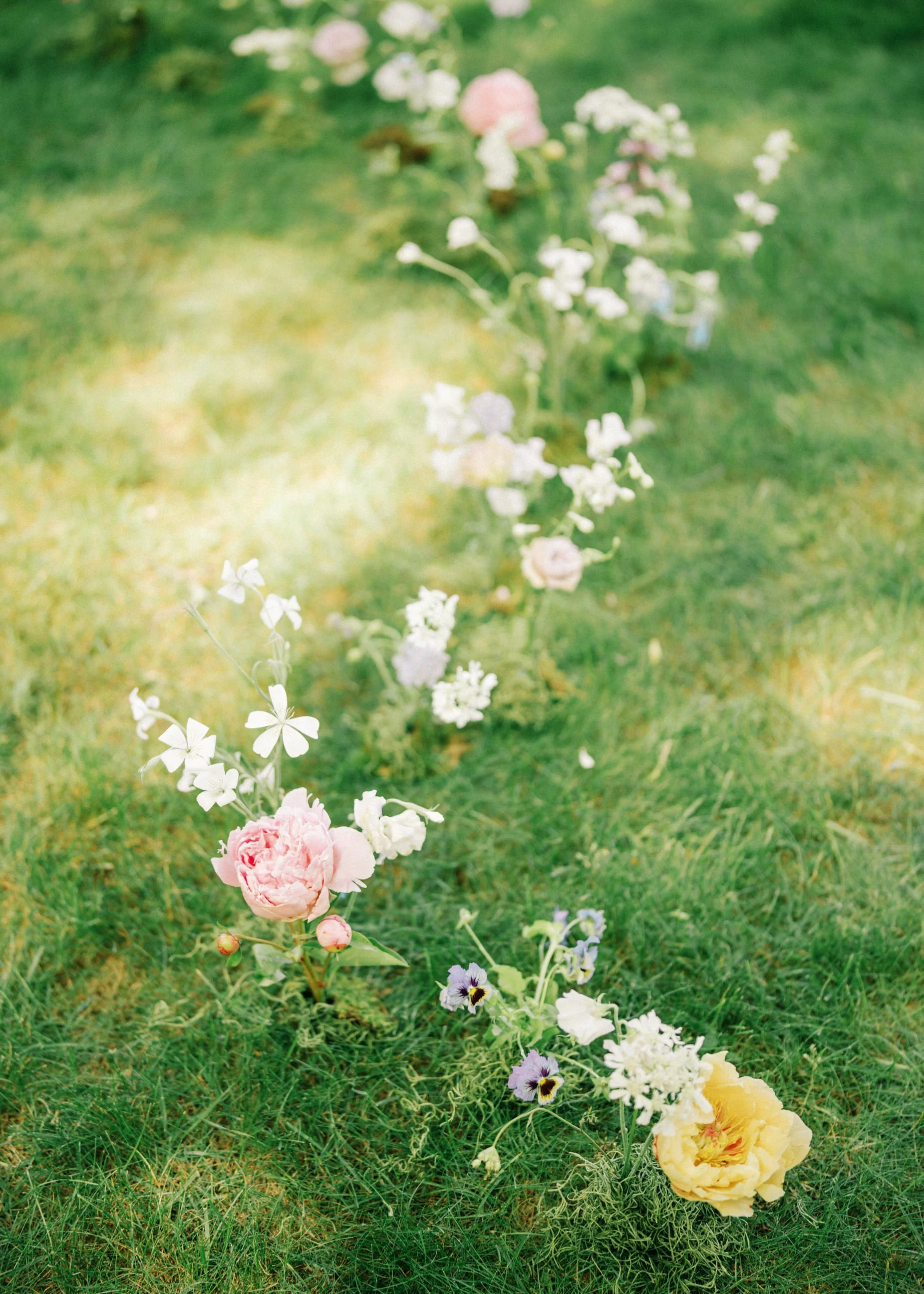 Thoughtful floral design woven into the grass at this private residence wedding in Michigan