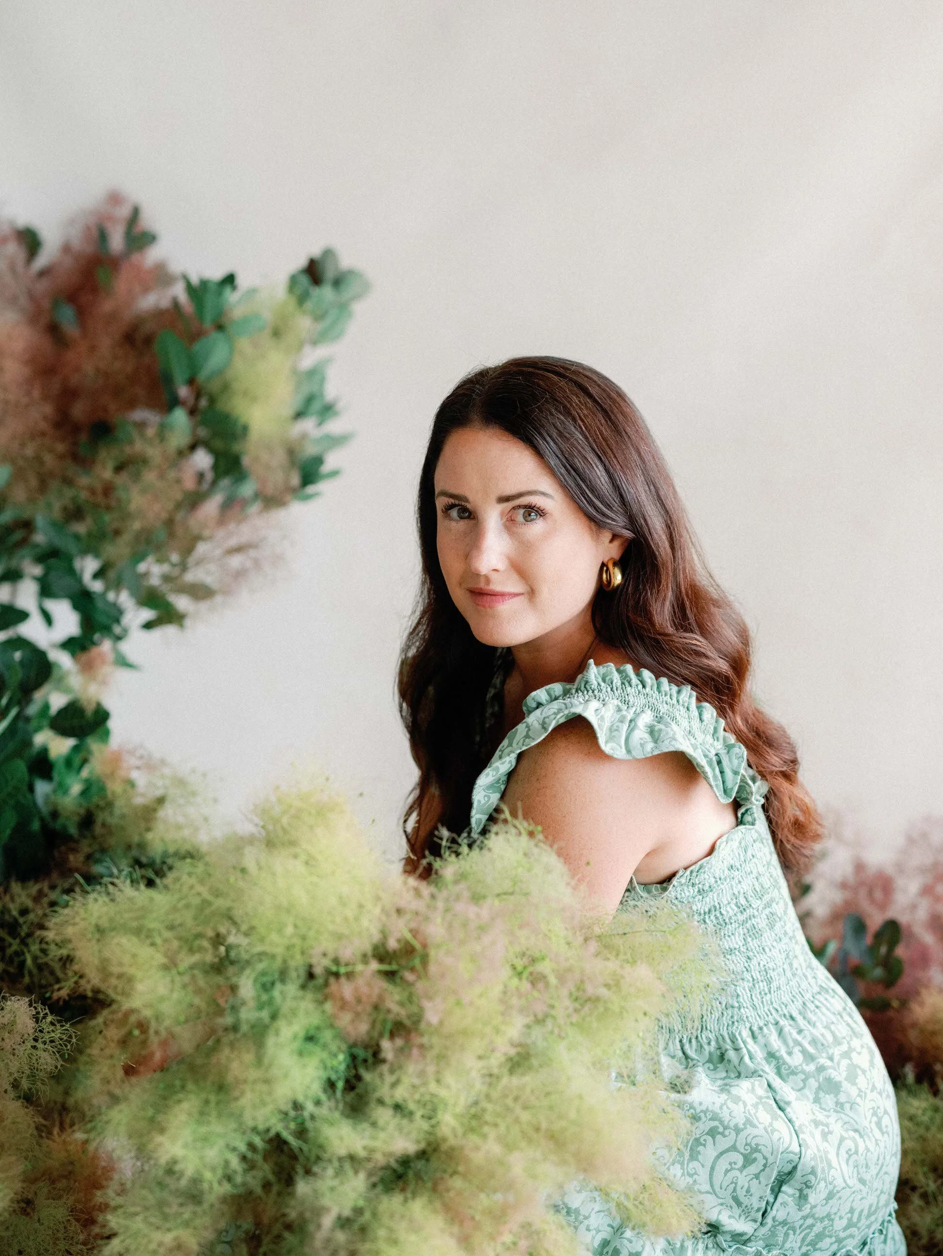 Rhiannon Bosse headshot with smoke bush installation