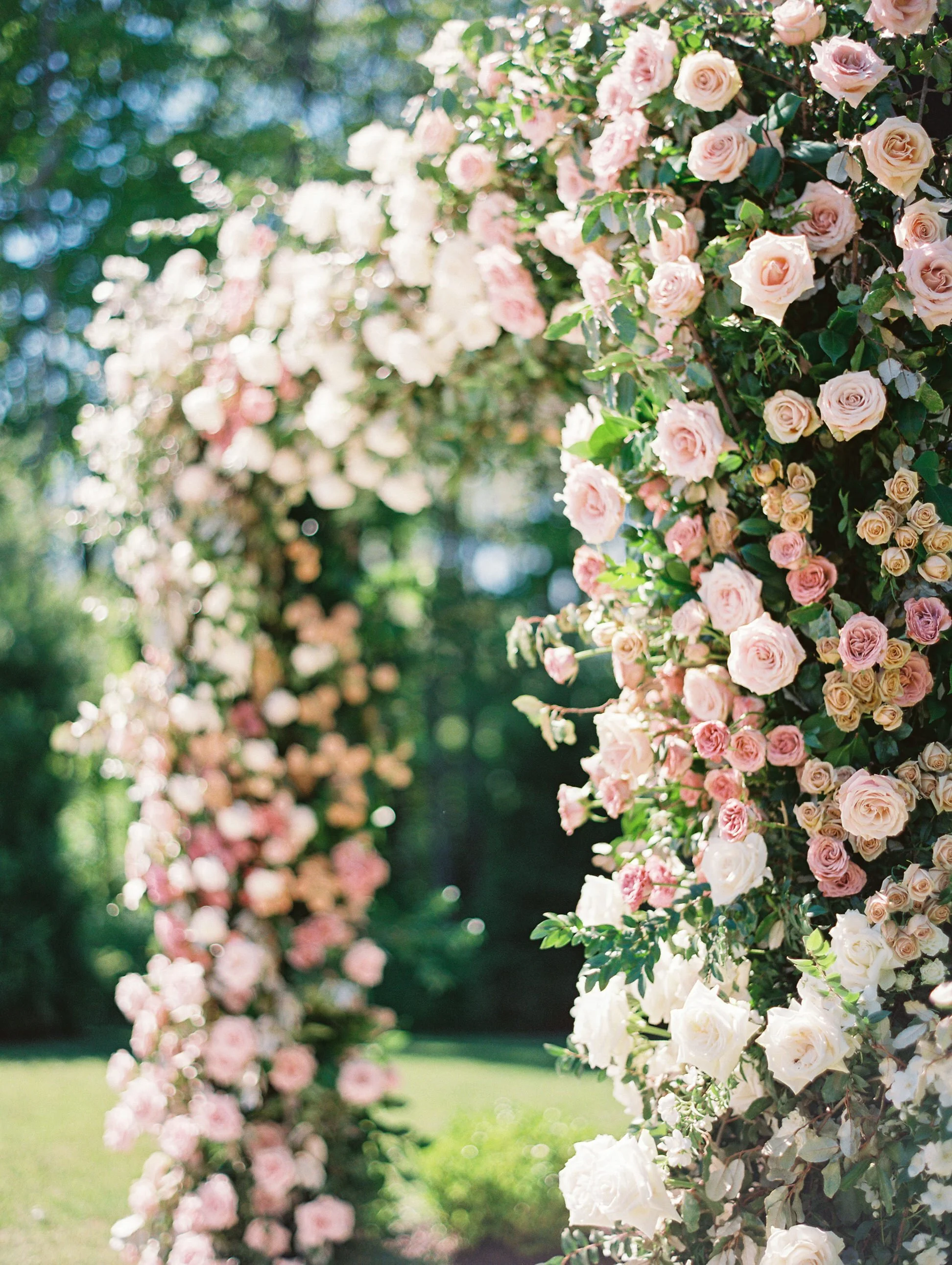 Pink florals and roses wedding arch for high end Michigan wedding ceremony