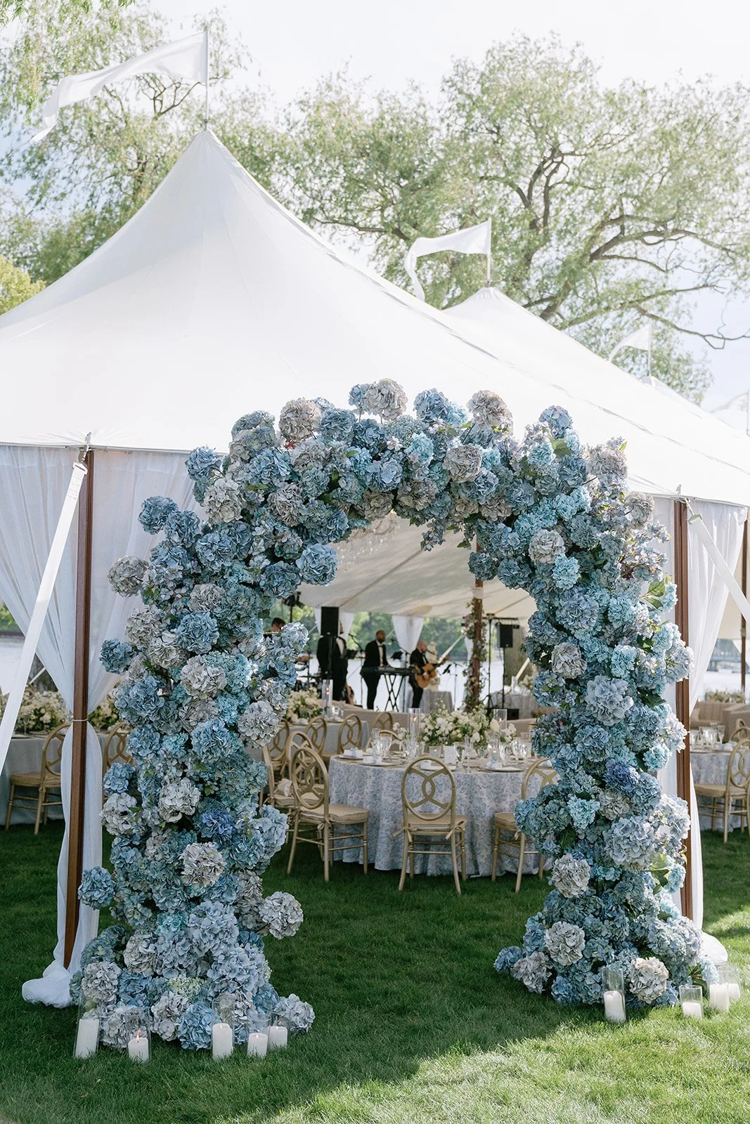 timeless and coastal inspired wedding reception design with stunning blue hydrangea archway