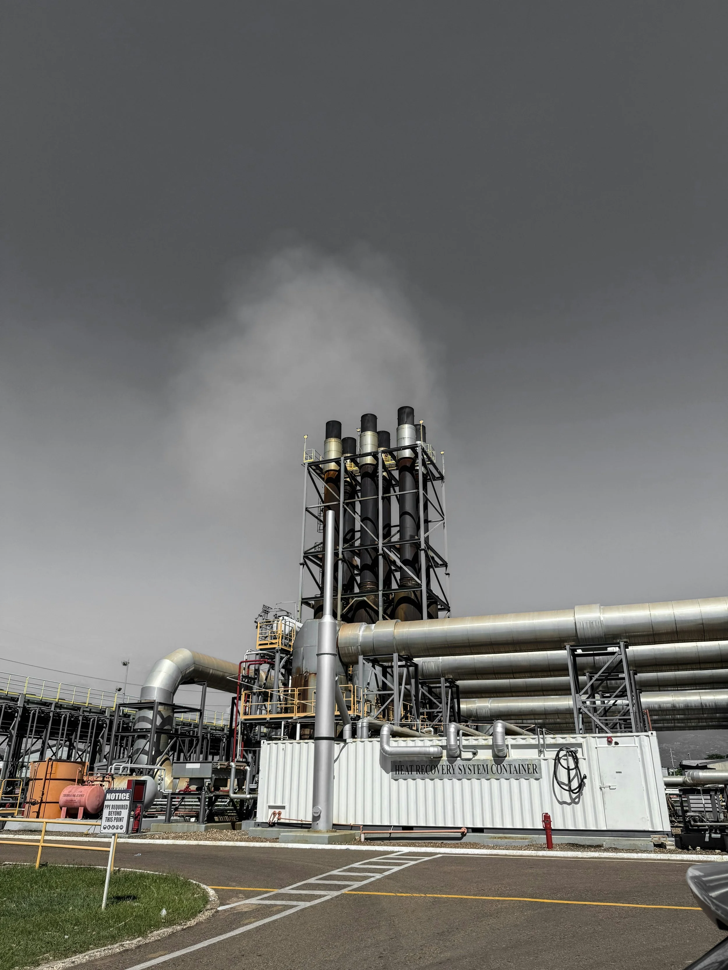 Industrial facility with metal pipes and a heat recovery system container.