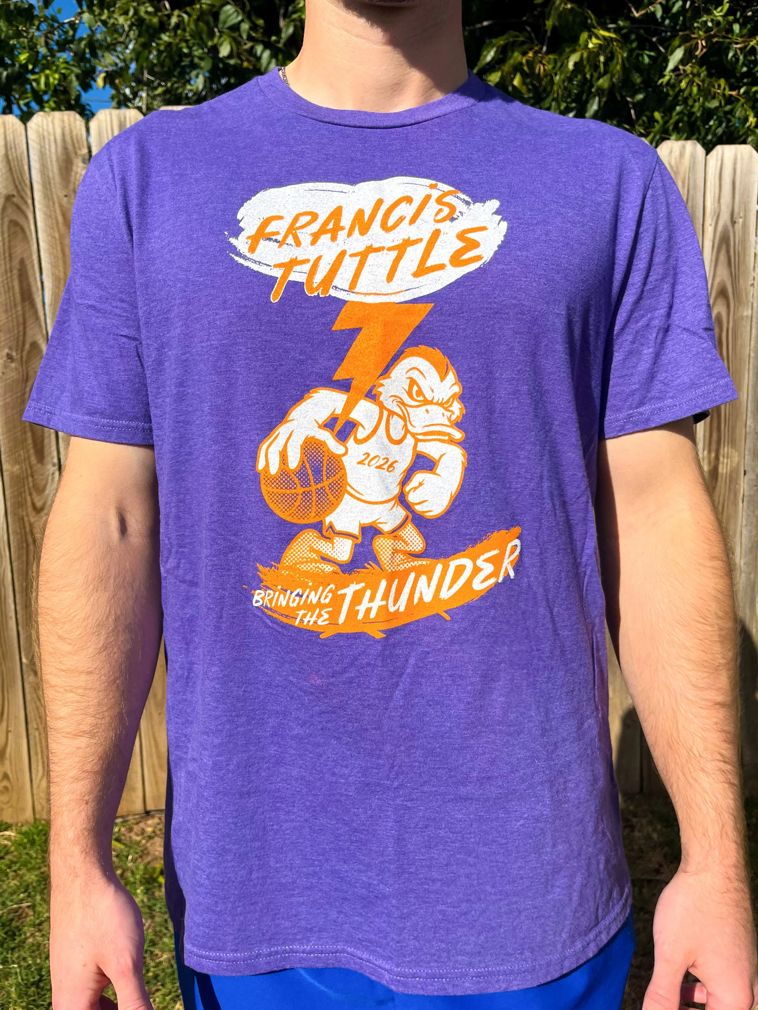 A vintage style screenprinted t shirt design of a cartoon duck playing basketball