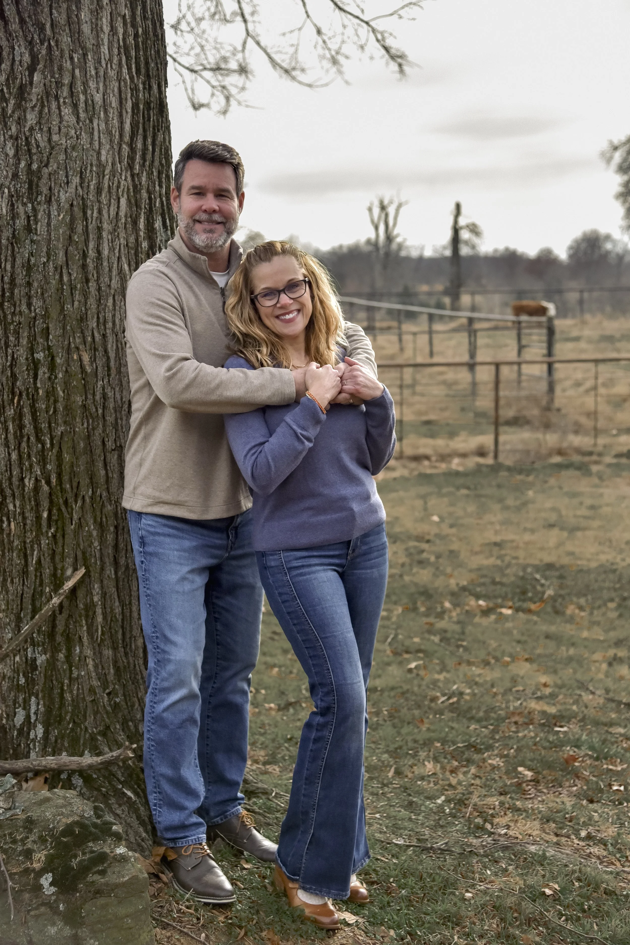 couple standing in front of tree 