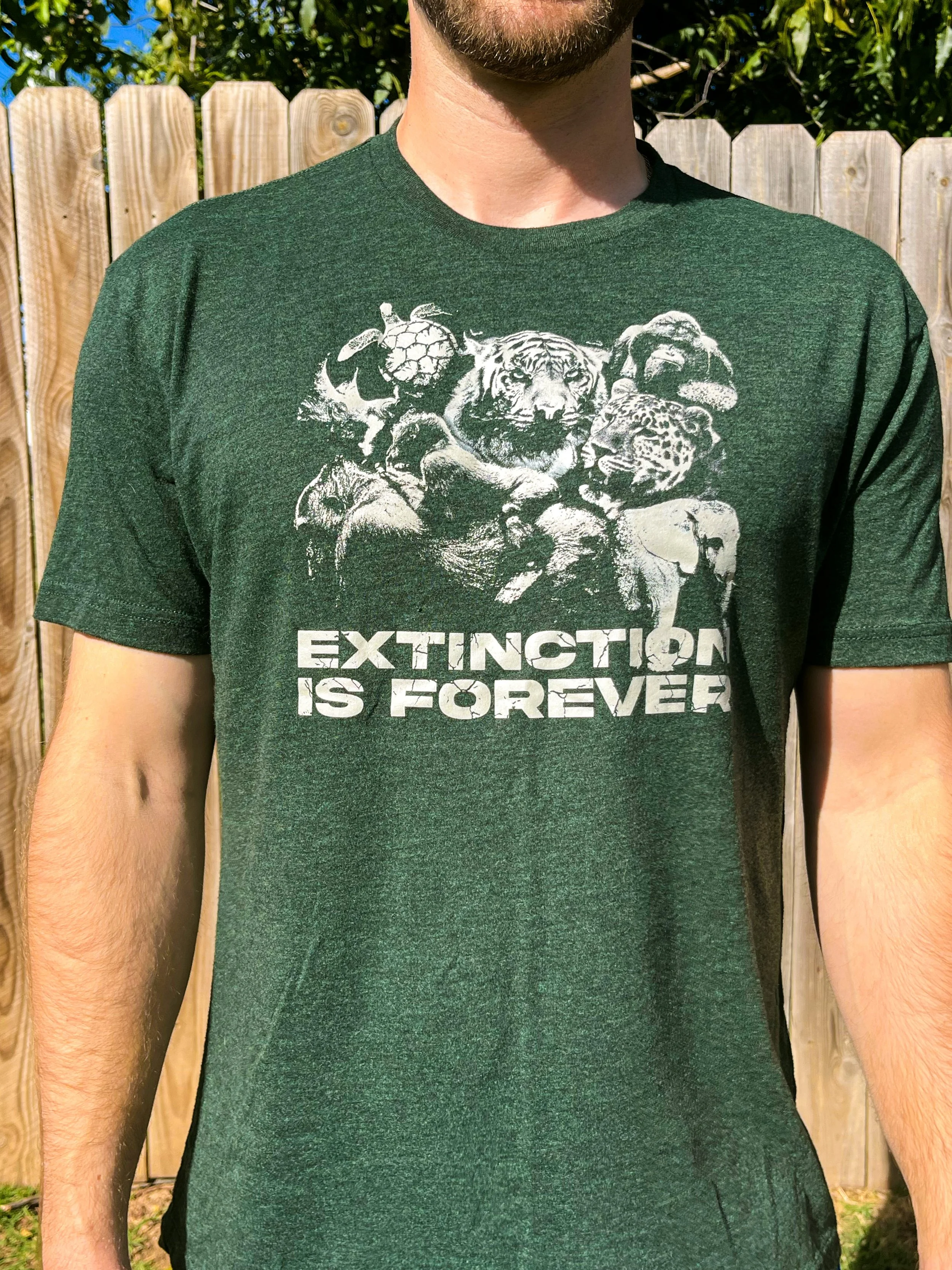 Green DTF shirt design of endangered animals with text "extinction is forever"