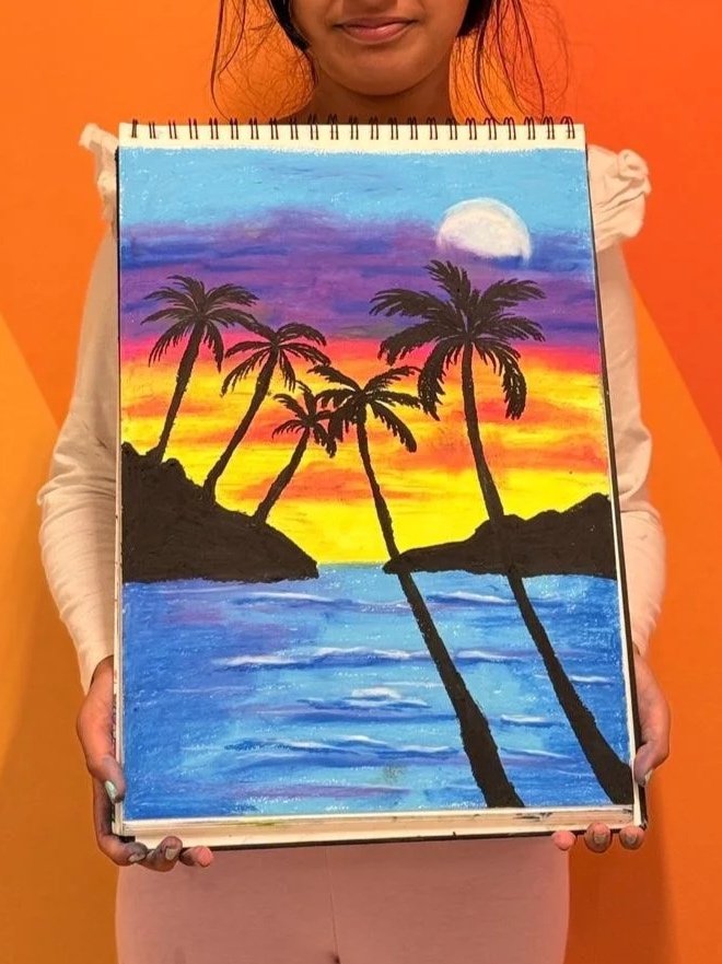 A student holding a painting made in acrylic at Oasis Art Studio, Vasant Vihar
