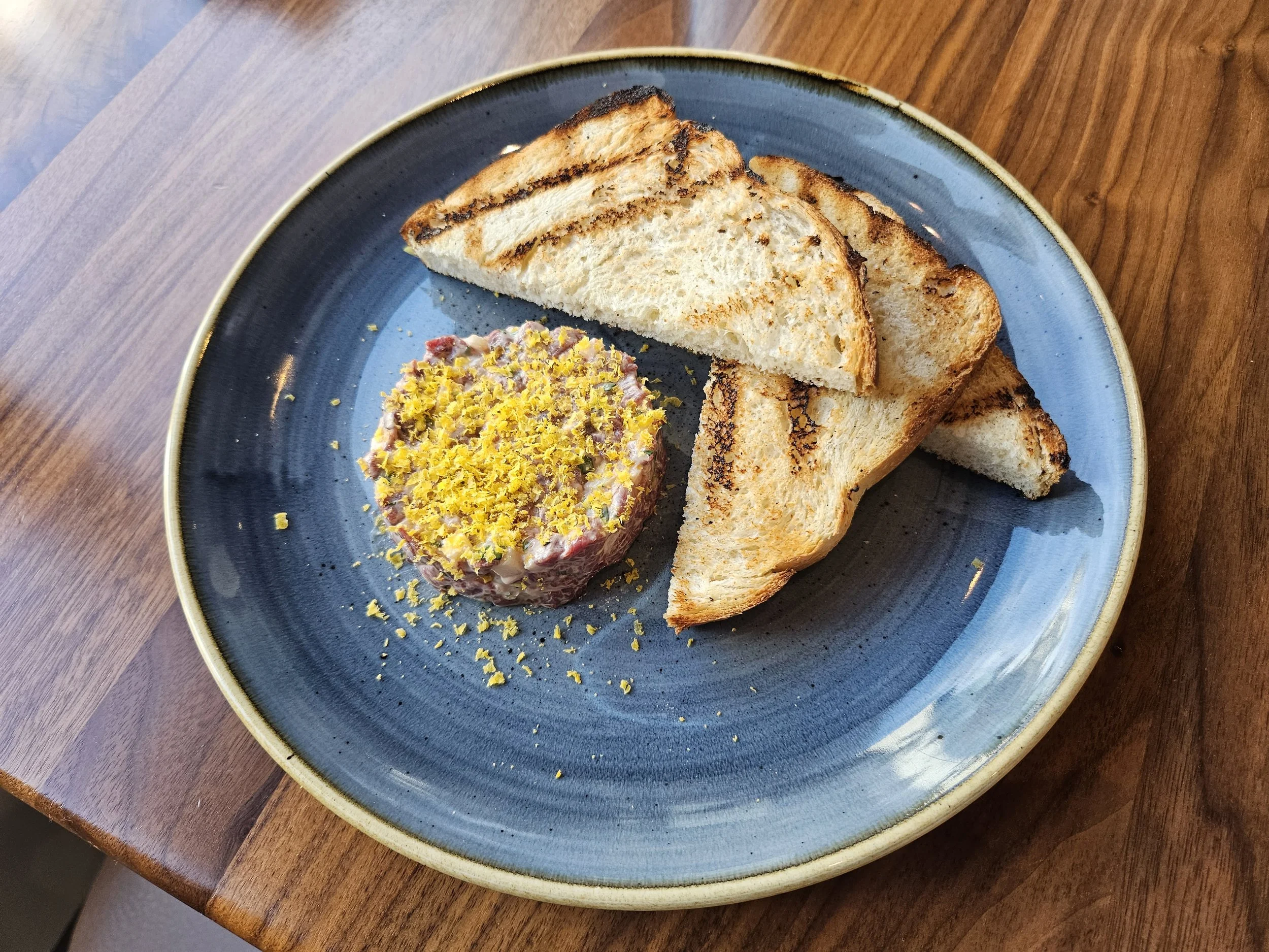 Venison tartar with grilled bread and cured egg yolk