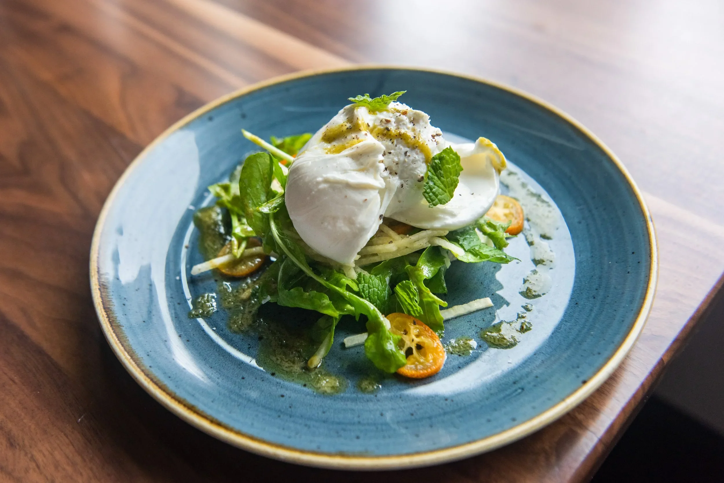 Burrata with kumquats, arugula, toast, and mint