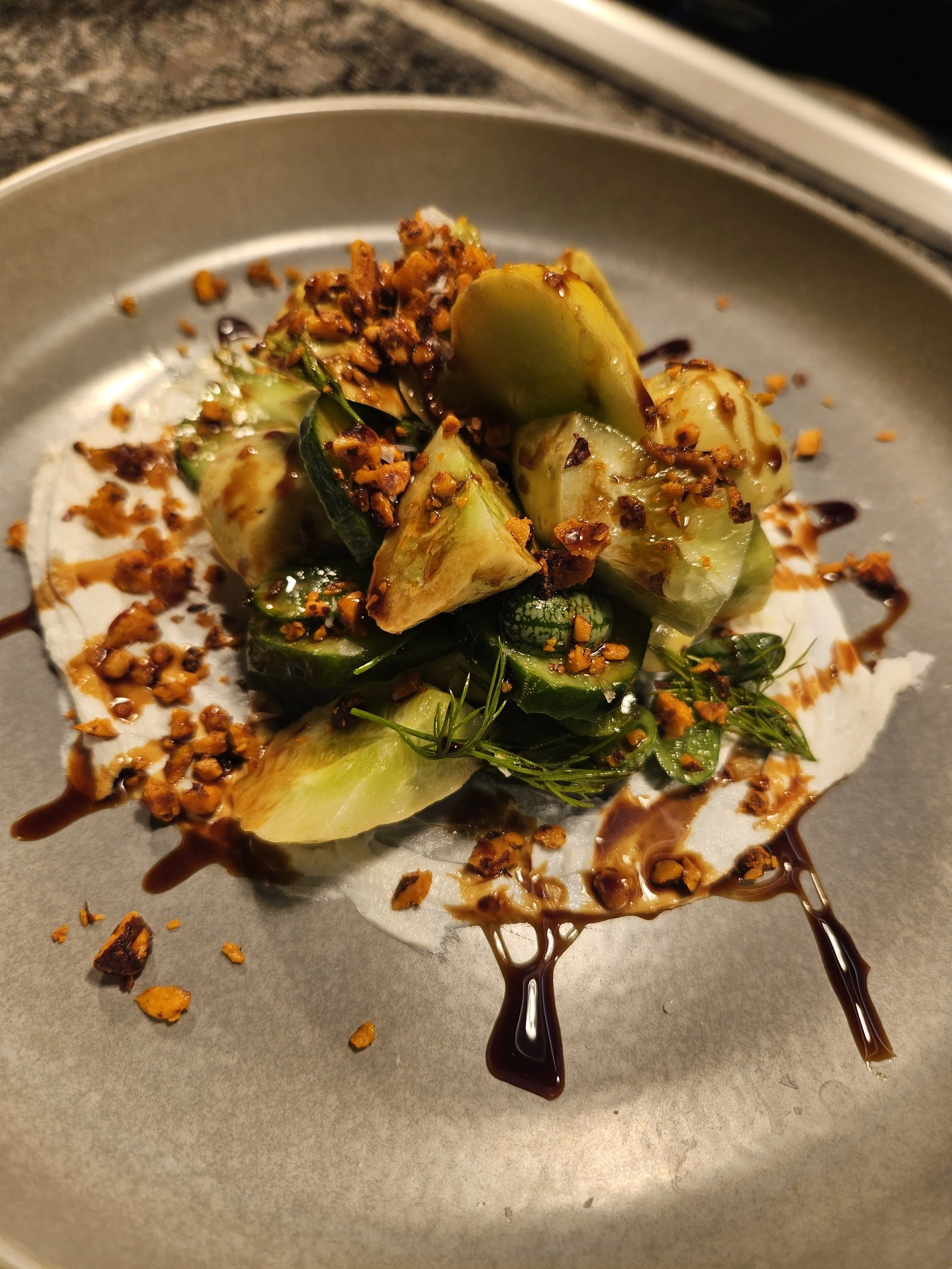 Mixed local cucumber salad with spicy marcona almonds, labneh, saba, and dill