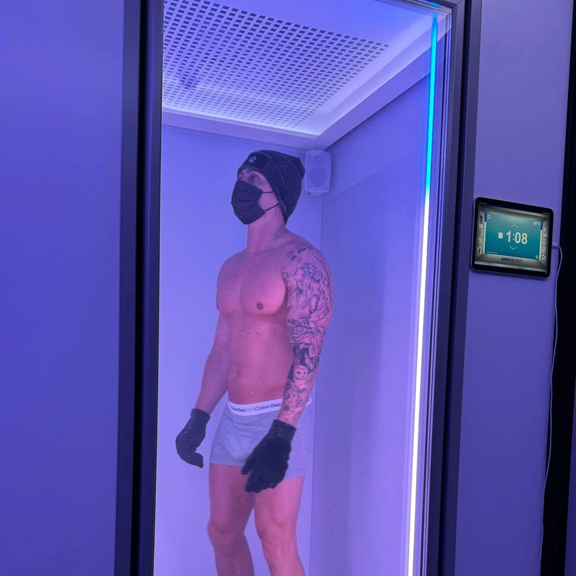 A repeat client is experiencing The Cold Room's Mecotec full-body cryotherapy chamber at -87°C, aiding recovery from regular gym training and Hyrox events.