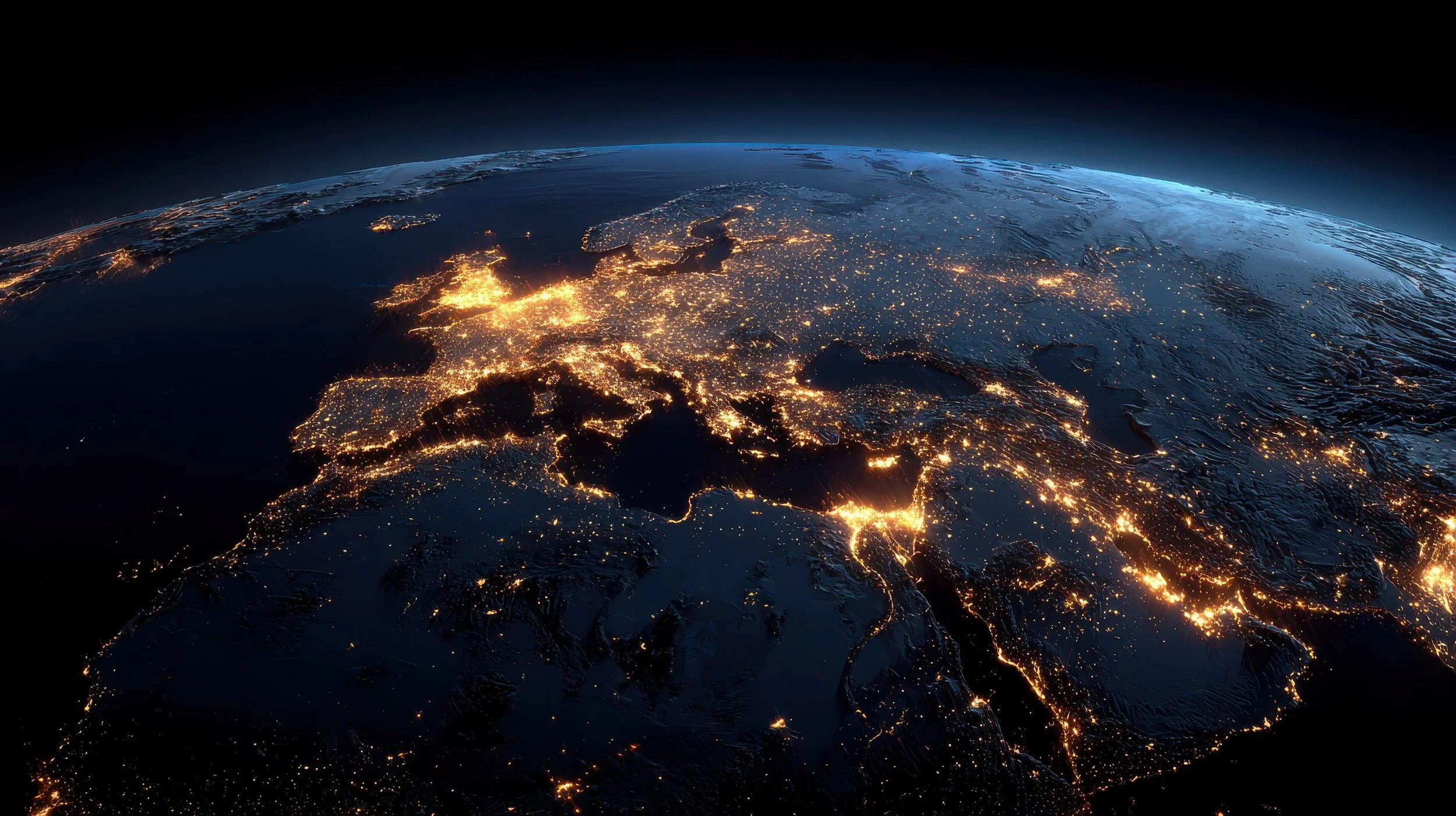 Nighttime satellite view of Europe showing illuminated city lights and land features, with a dark sky above.
