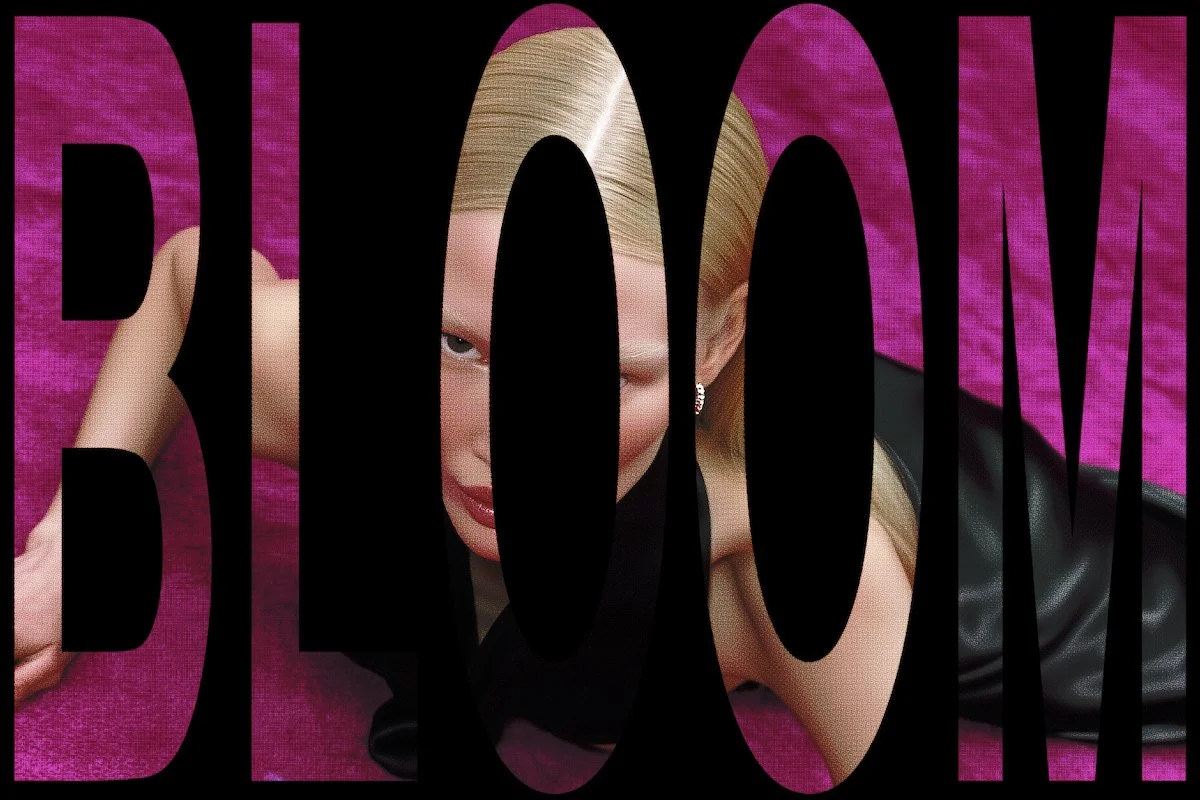 A woman with blonde hair lying on a pink textured surface, partially obscured by large black text that spells 'BOOM'.