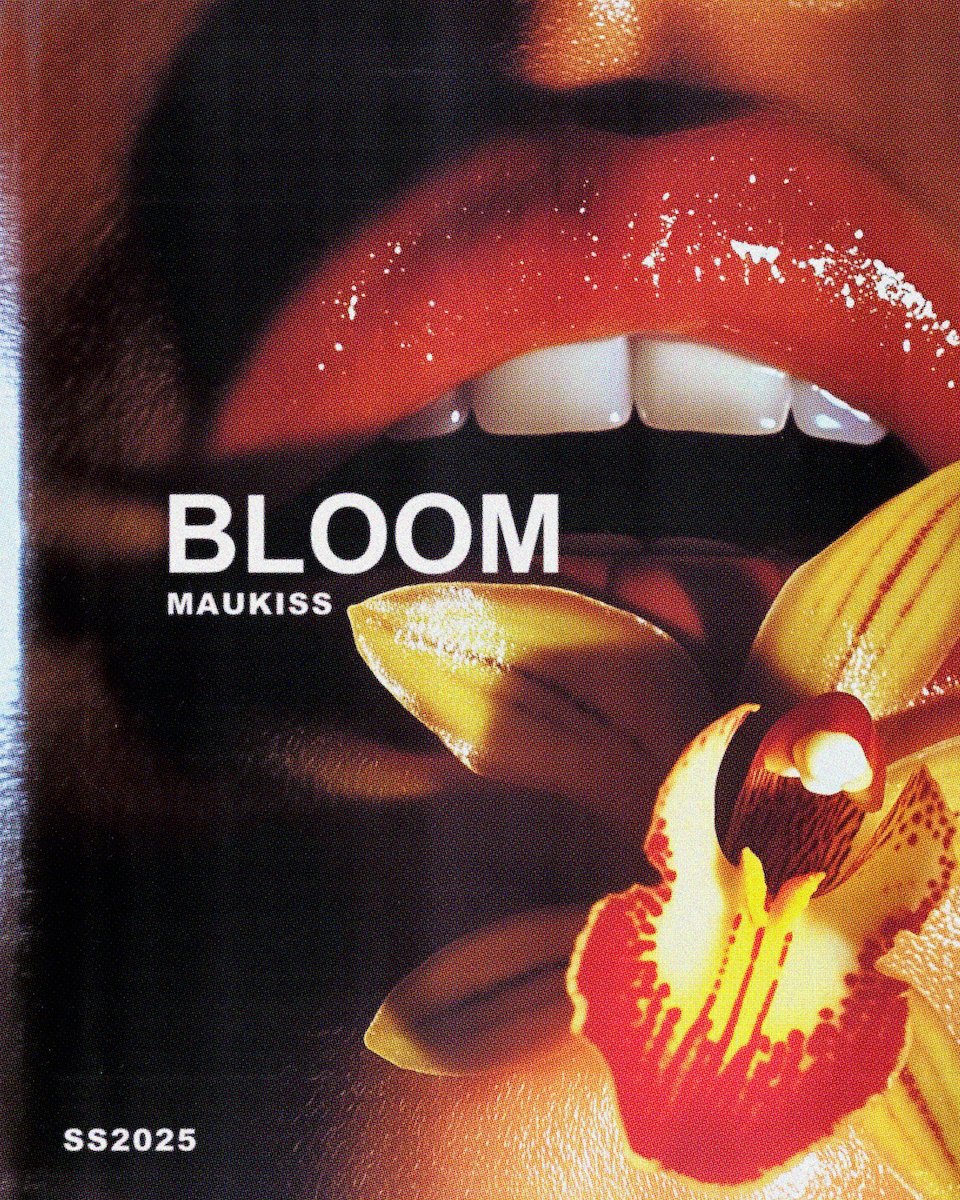 Close-up of open lips with glossy red lipstick, biting a yellow orchid flower with red markings, and text "BLOOM MAUKISS" and "SS2025".