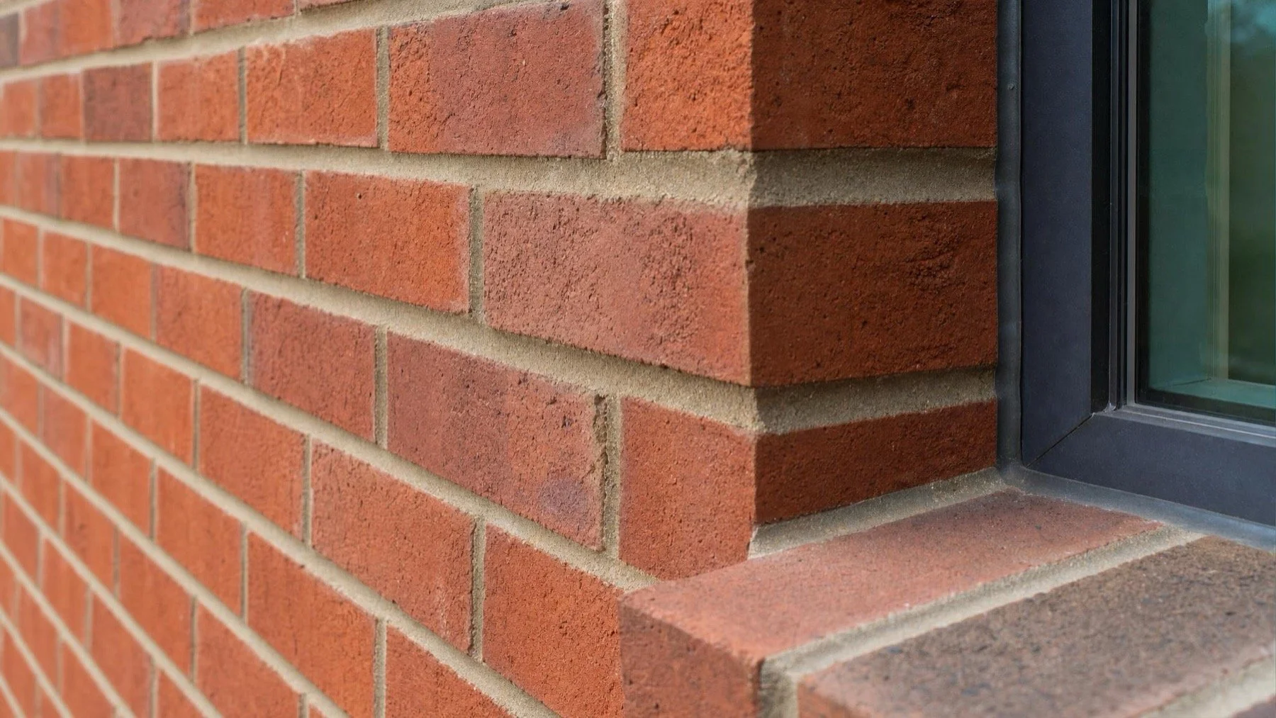 Red brick window reveal showing wall thickness on a Toronto home