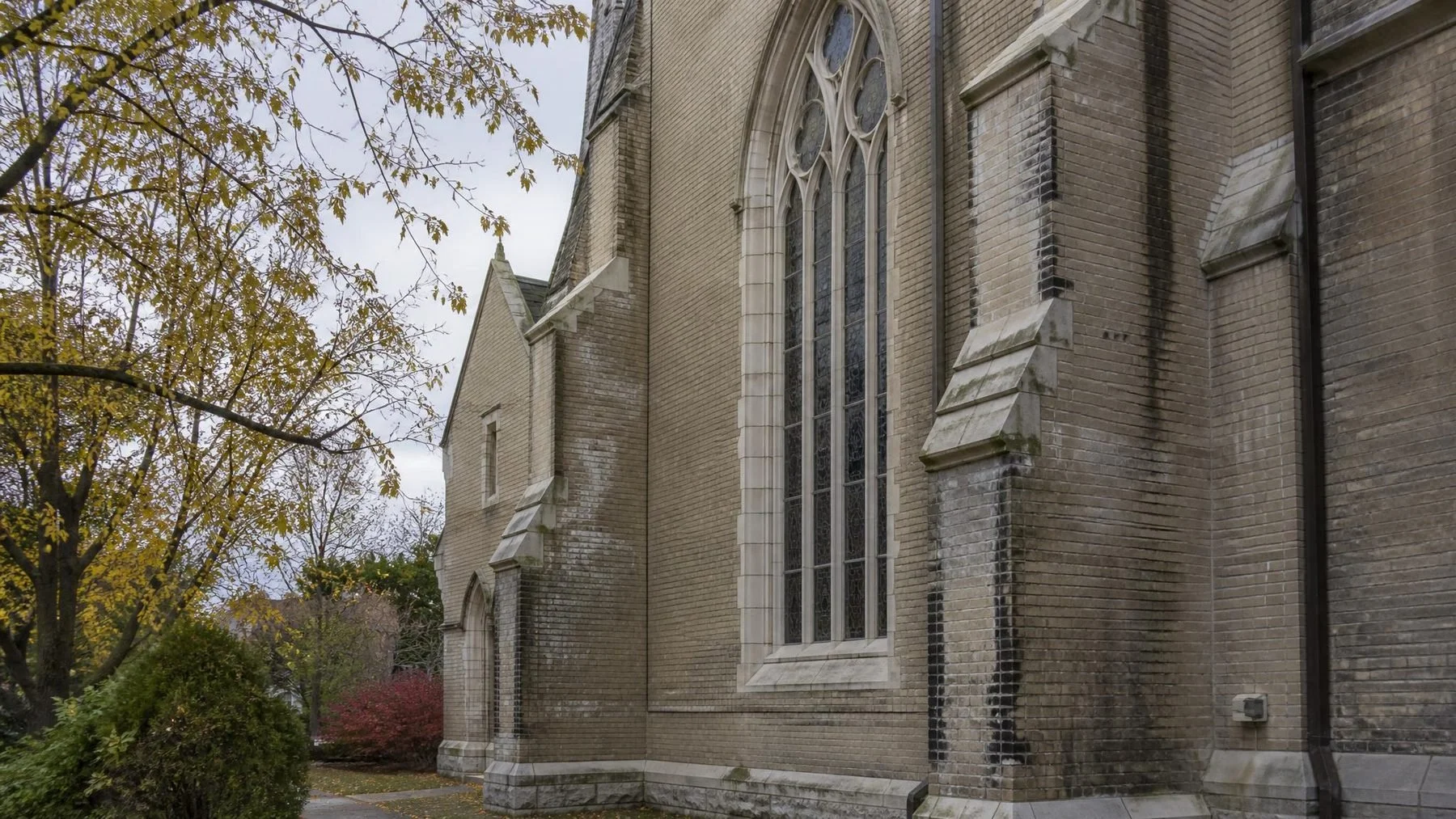 Toronto stone church exterior with an arched window and weathered masonry
