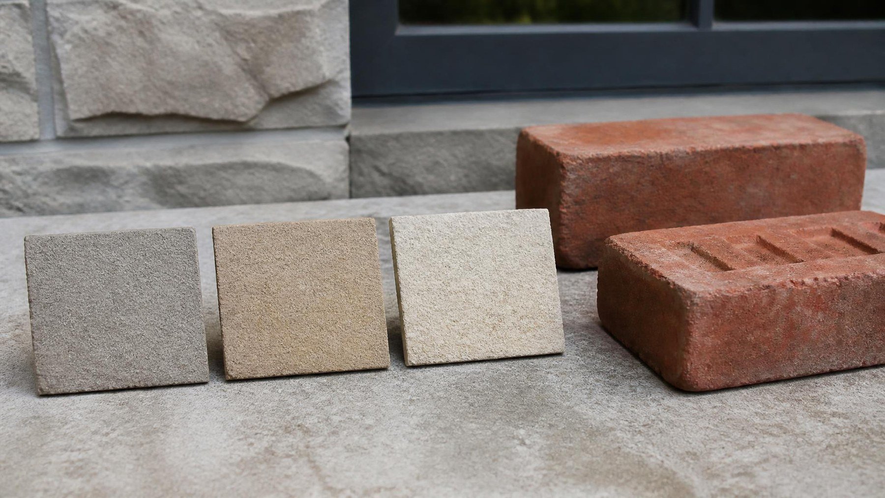 mortar samples and masonry repair tools beside an older brick wall