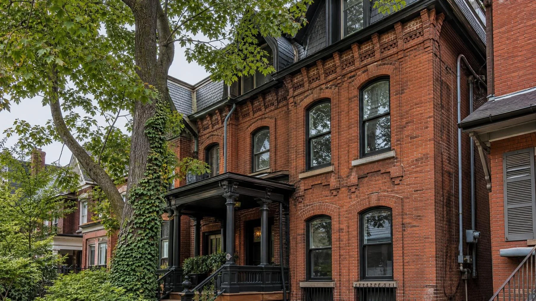 Victorian Toronto row house facade with corbelled brick and eroded mortar joints