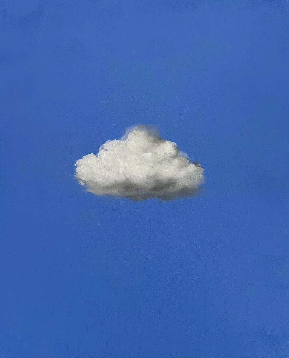 A single, fluffy white cloud against a clear blue sky.