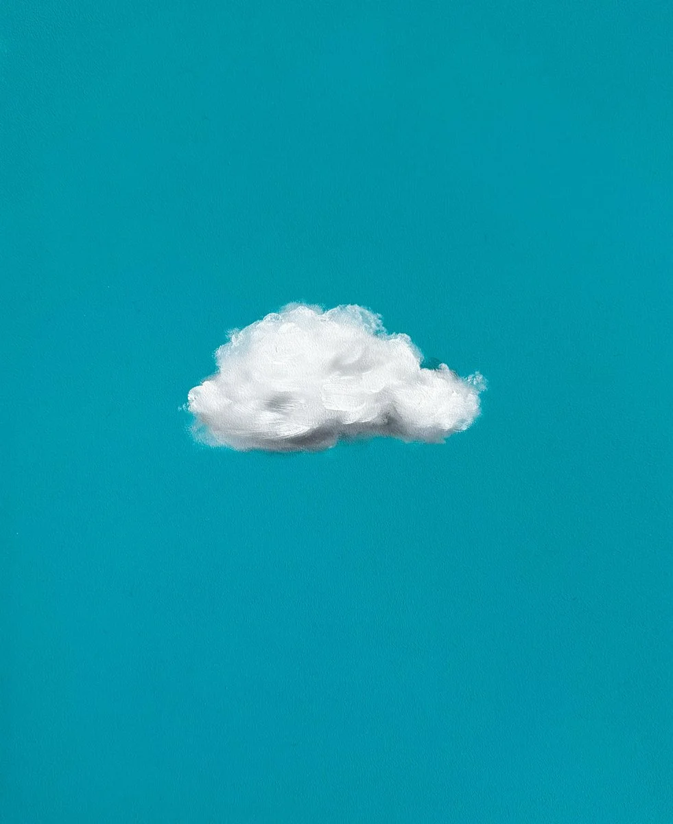 A single white cloud against a clear blue sky.