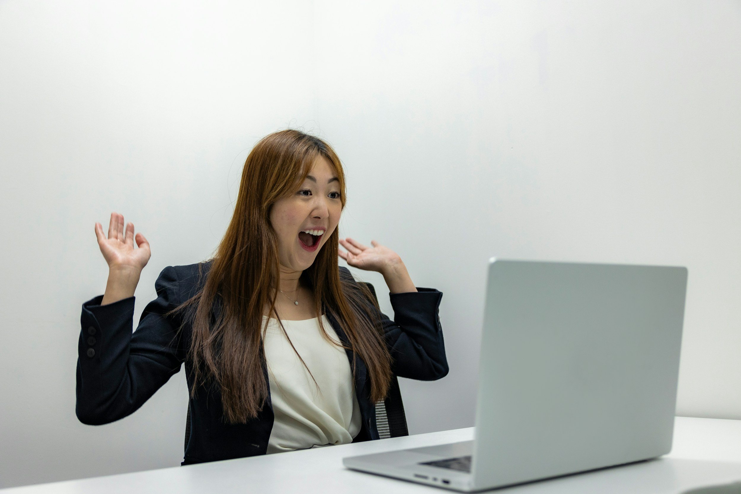 A learner reacting with excitement to her AI Pronunciation Report, seeing measurable progress in her pronunciation.