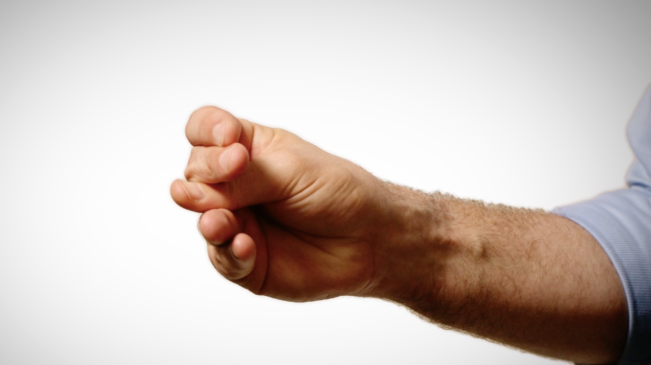 A close-up of a hand demonstrating a Kinetic Phonetics® gesture, the hand movements SpeakEasy learners use to anchor precise pronunciation.