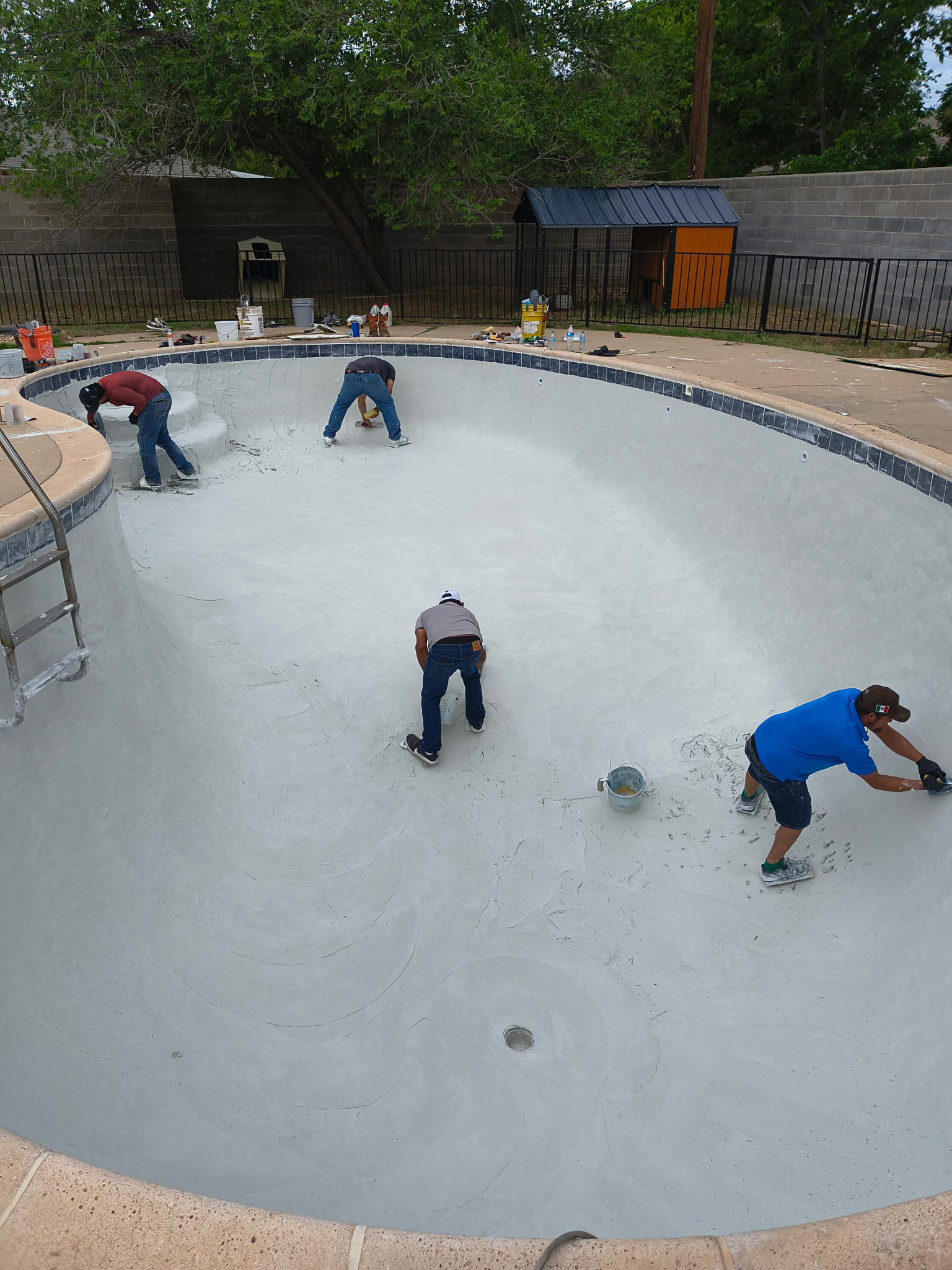 People renovating a swimming pool.