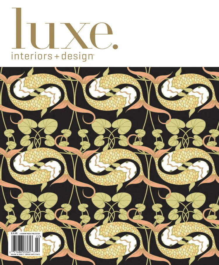 Cover of Luxe Interiors + Design magazine featuring a repeating pattern of yellow and black snakes intertwined with green ivy on a black background.