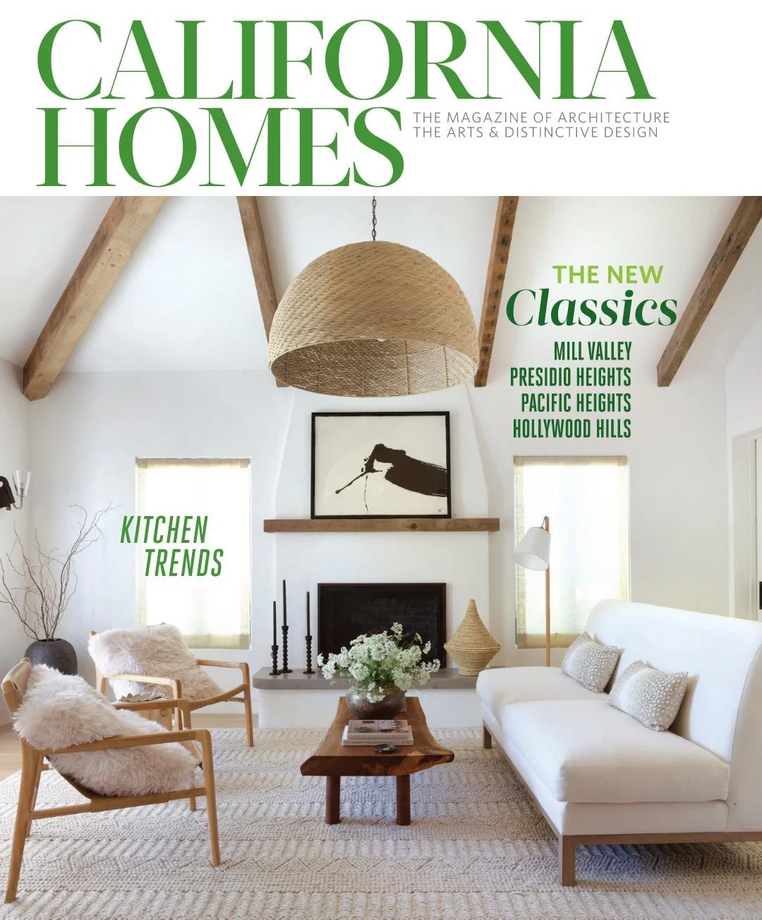 Magazine cover titled California Homes featuring a minimalist living room with white walls, a white sofa, wooden chairs with fluffy cushions, a wooden coffee table, and decorative elements like a large woven pendant light, artwork, and plants.