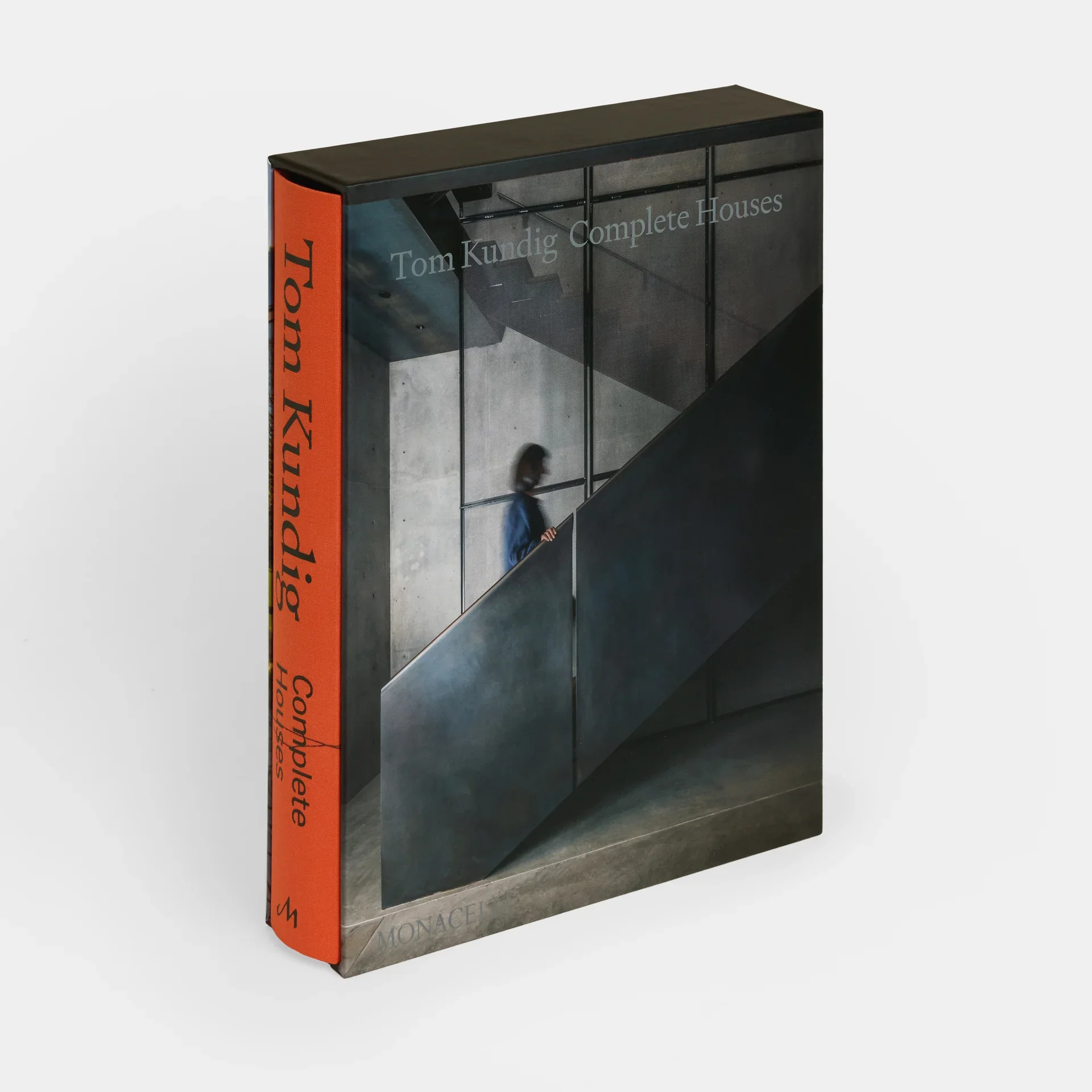 Close-up of a book titled "Complete Houses" by Tom Kundig, featuring Shawback Studio.