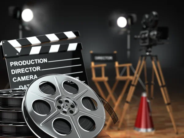 Film reel, a movie clapperboard, and film rolls in a film studio with cameras, director chairs, lights, and a red cone in the background.