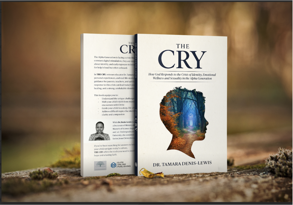 A book titled 'The Cry' by Dr. Tamara Denis-Lewis stands upright on a textured surface outdoors with a blurred autumn background. The book cover features a silhouette of a person's head filled with a forest scene of trees and a pathway. The back cover is partially visible, with text and a black-and-white photo of the author.