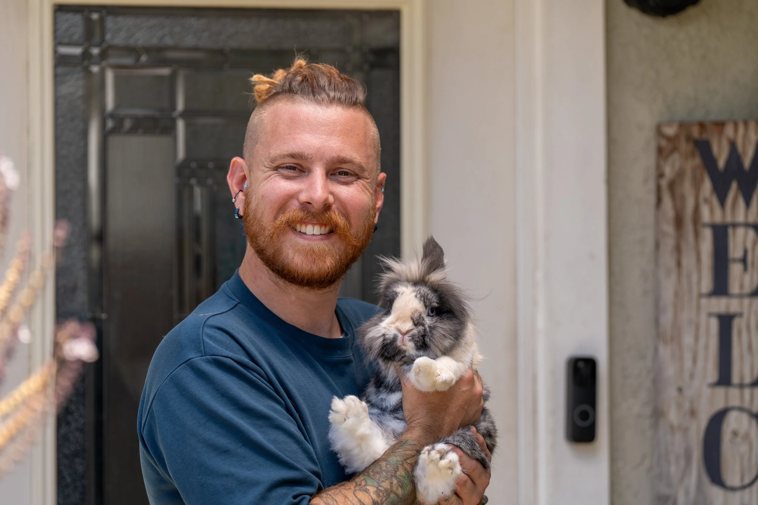 Brandon Schooner holding his fluffy rabbit Pixie.