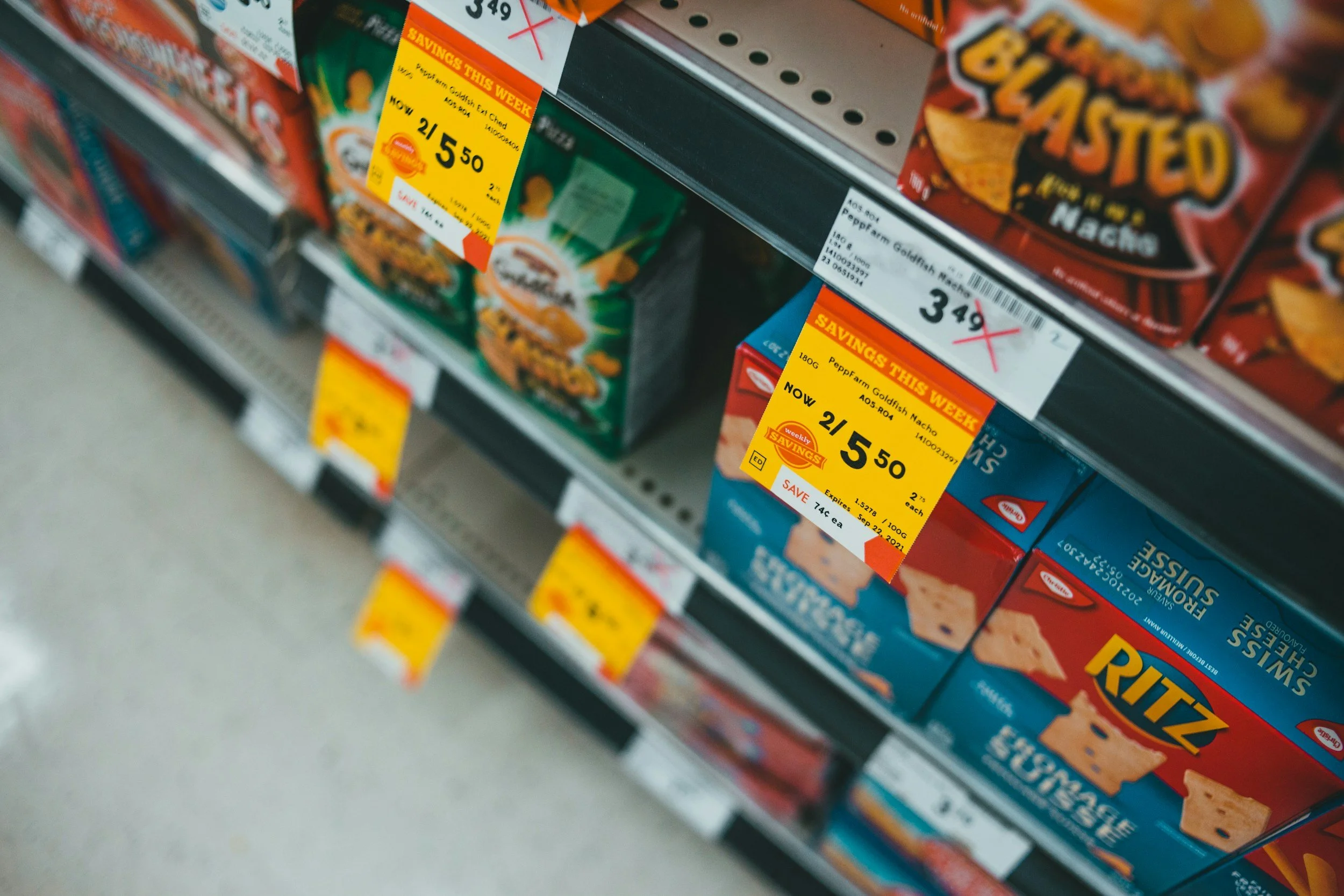 Dry grocery store shelves price tags for Ritz crackers