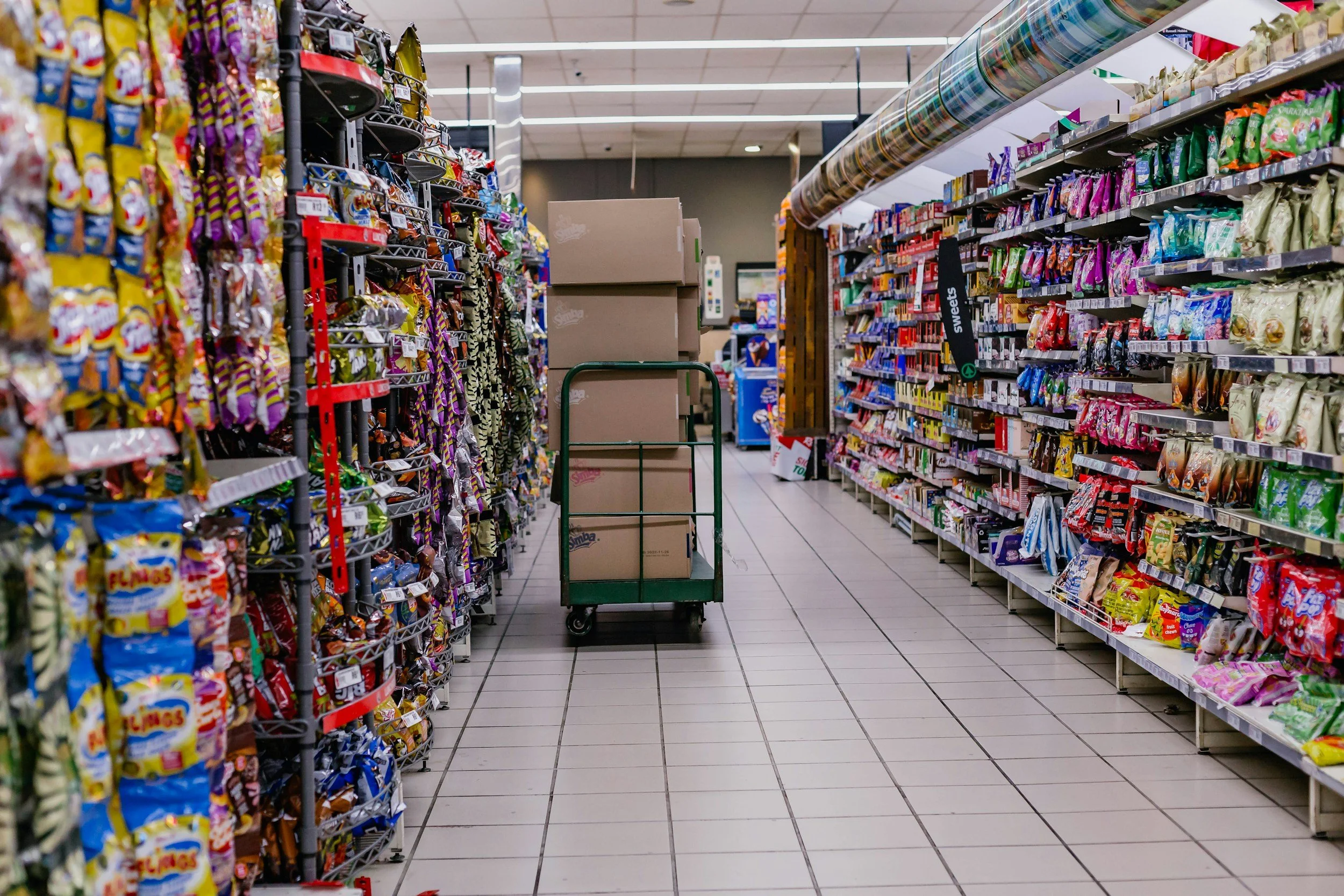 Uboat cart with boxes of chips to be stocked on grocery aisle shelves