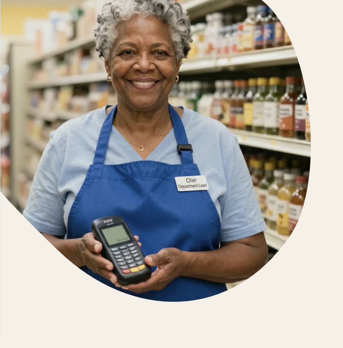 person with blue apron and name tag holding a mobility device