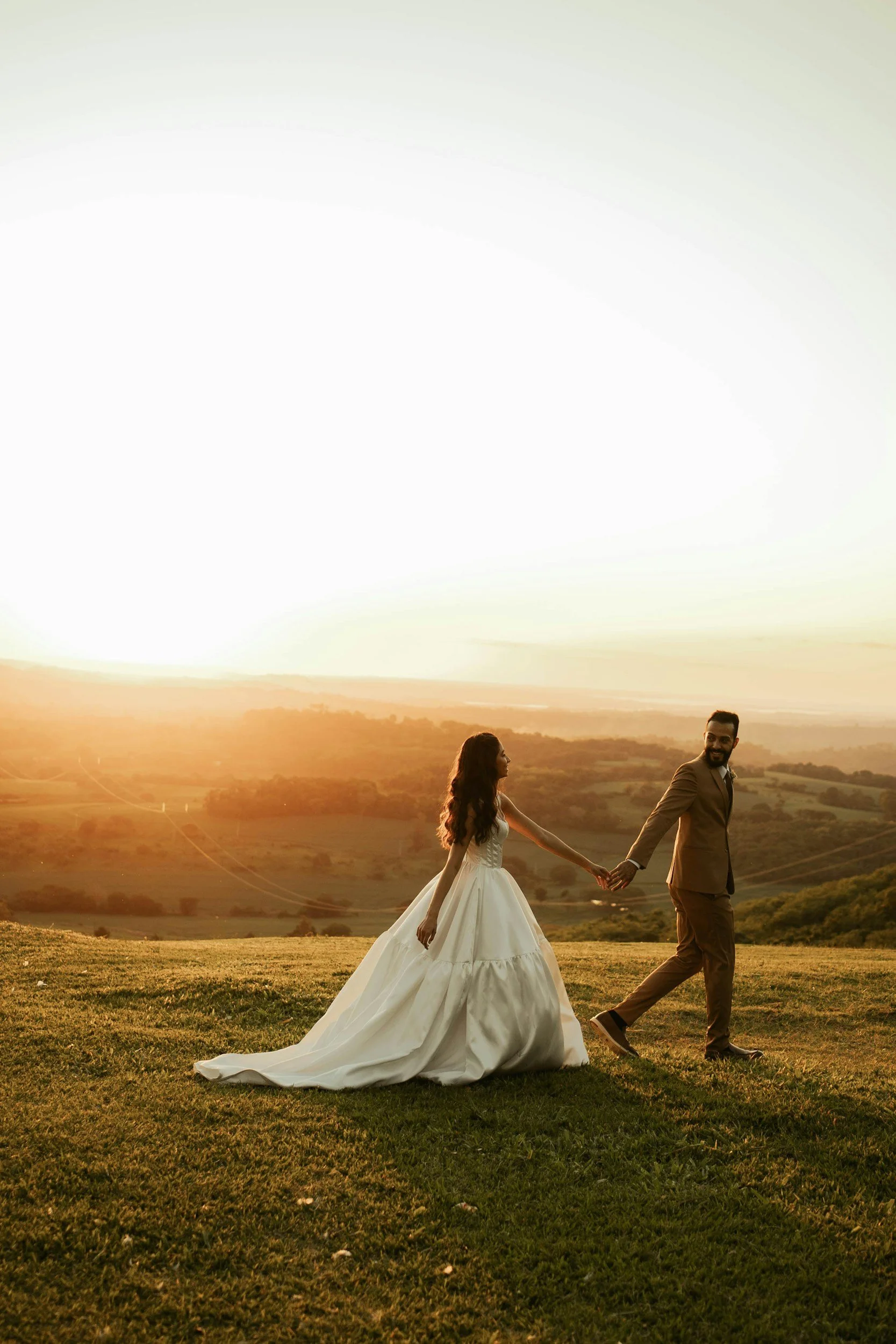 A bride and groom standing in the countryside of Portugal on wedding day with wedding-coordinator