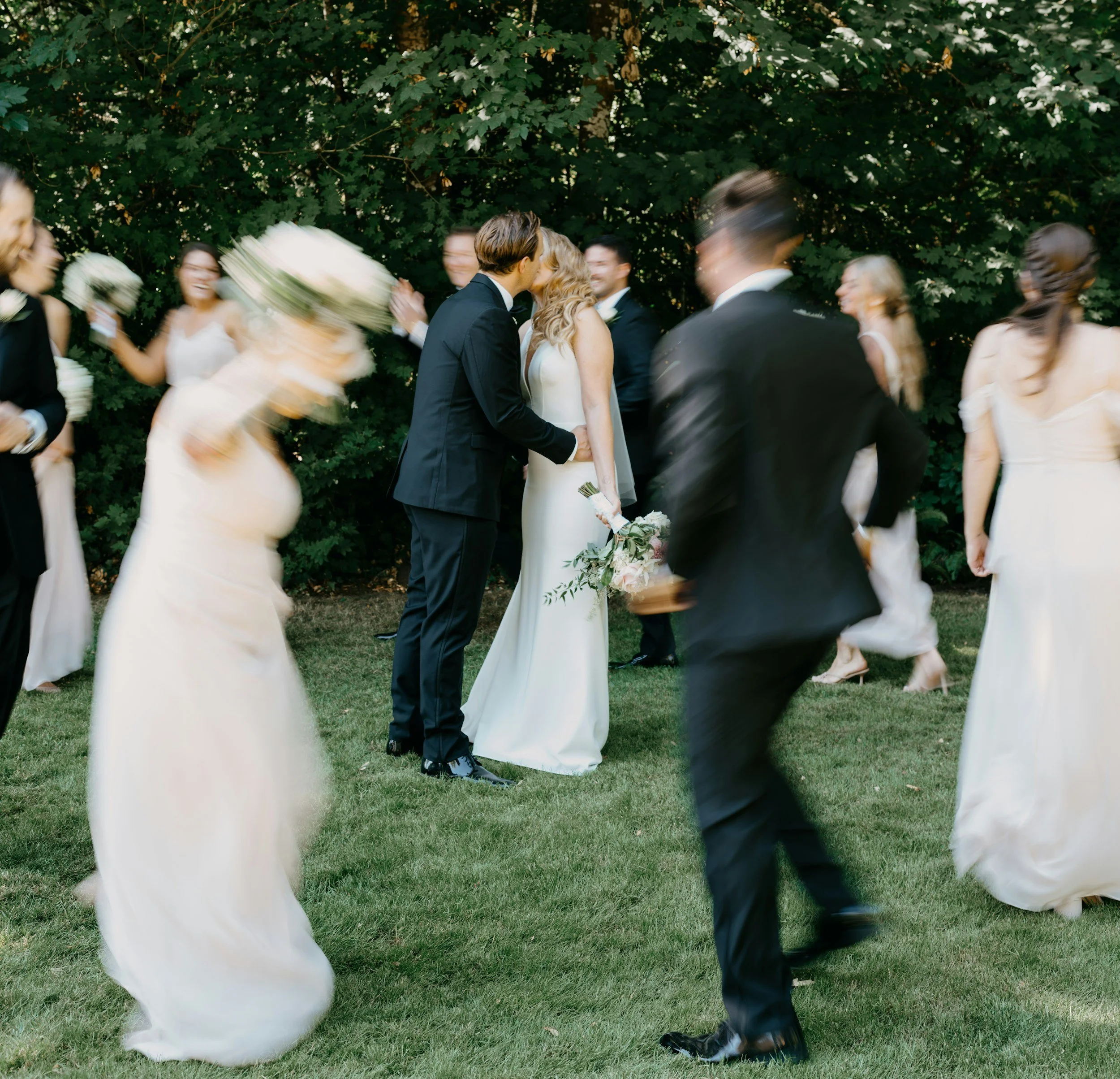A bride, groom, and wedding guests celebrating outdoors on a lawn during a seamless, professionally coordinated destination wedding in Lisbon, Portugal.