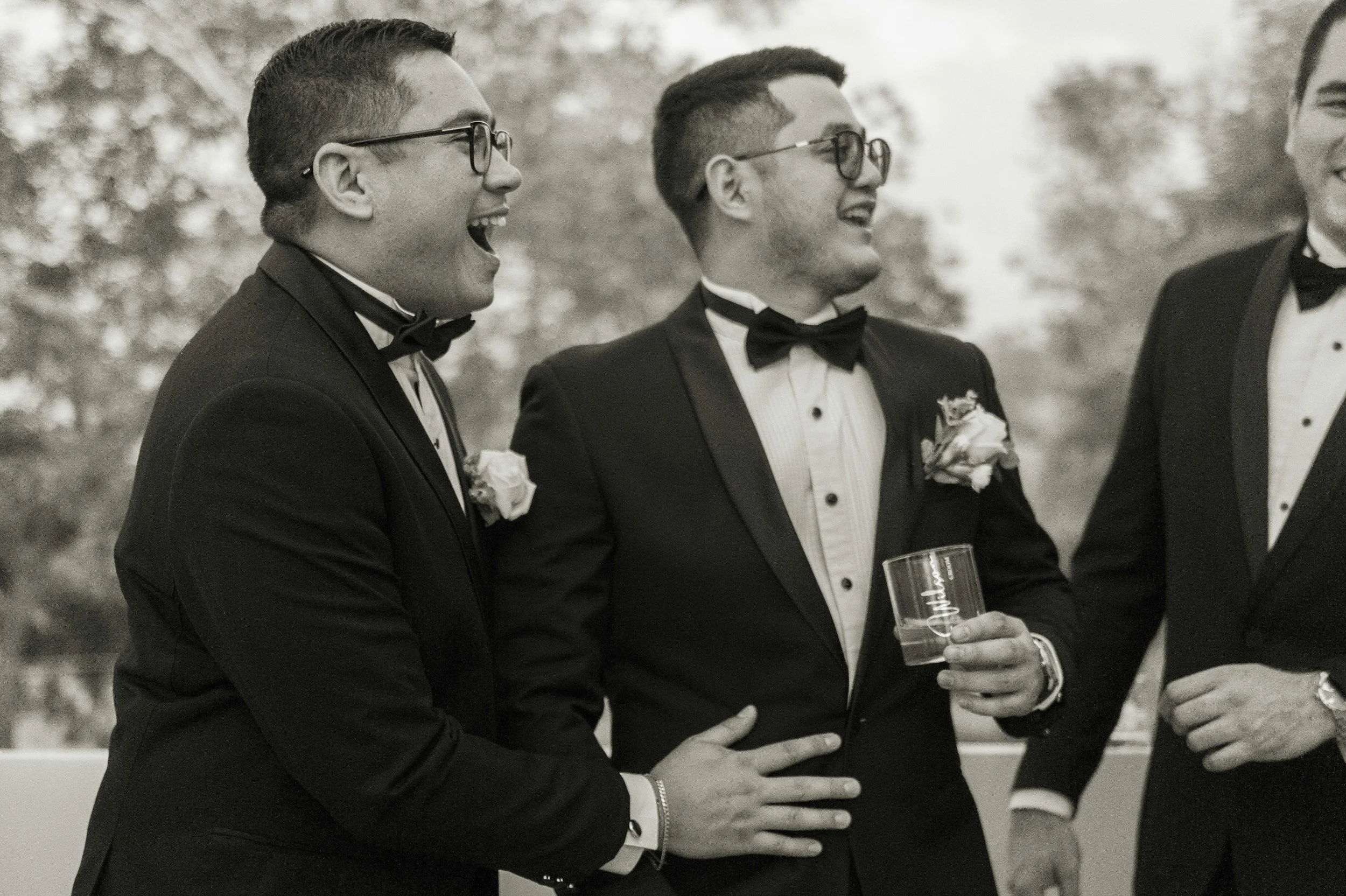 Gay grooms and wedding guests celebrating Portugal wedding outdoors on a lawn during a seamless, professionally coordinated destination wedding in Portugal.
