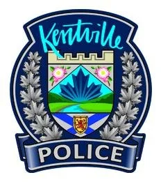 Kentville Police badge featuring a mountain and shield with laurel branches.