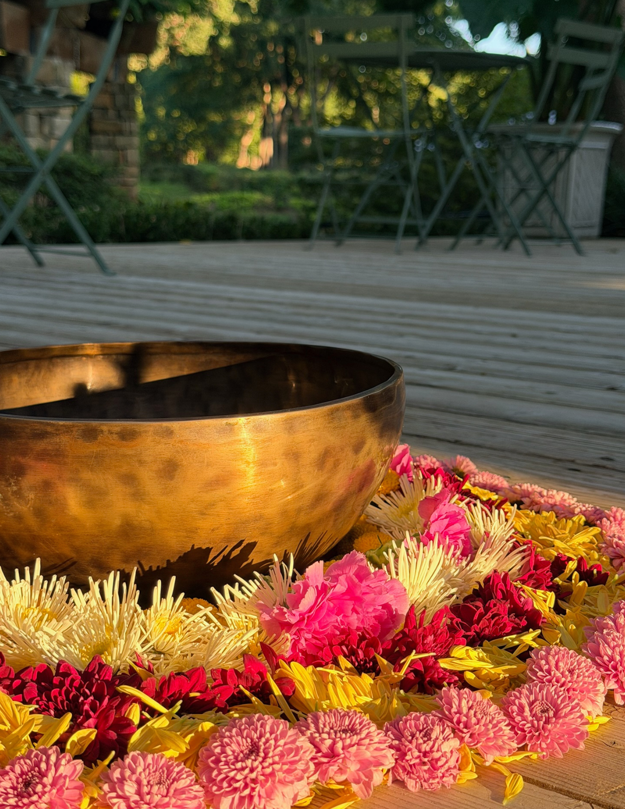 Singing bowl surrounded by colorful flowers during a Nuevo Om sound meditation in Grapevine, Texas.
