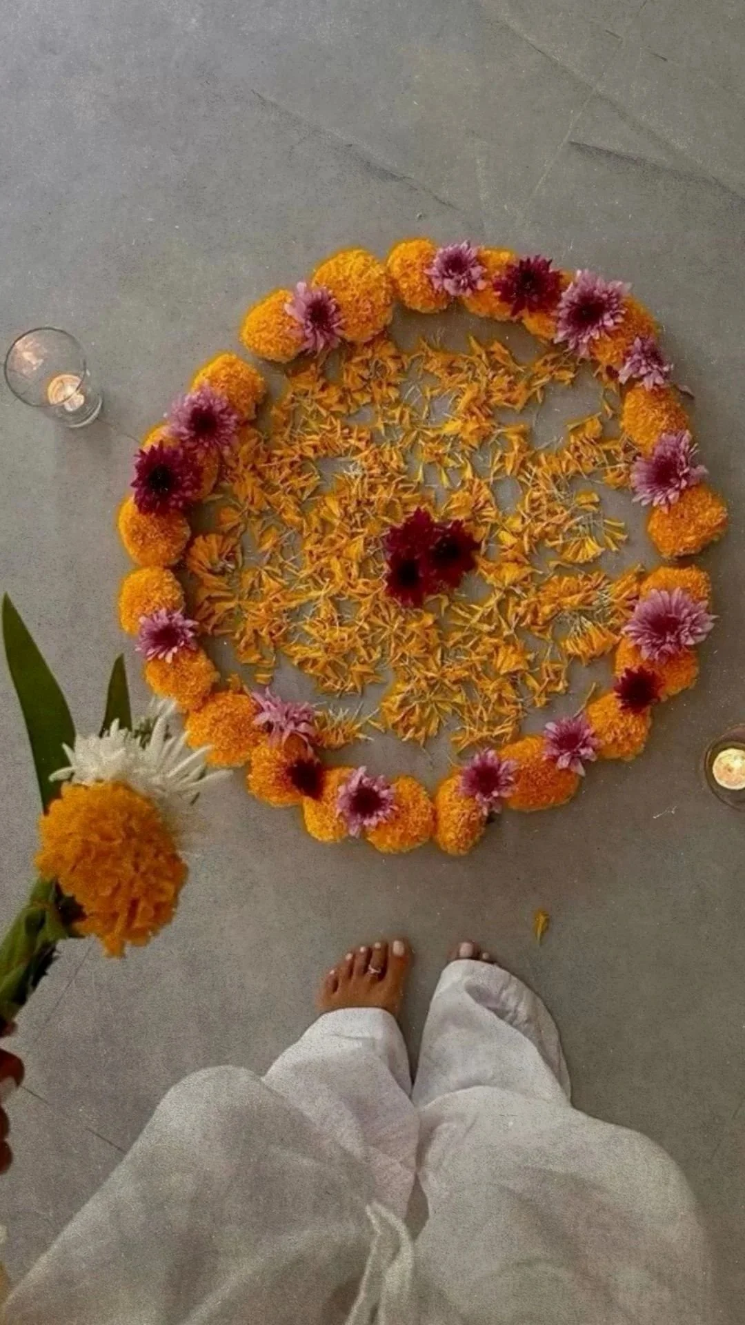 Marigolds and colorful flowers arranged in a circular ritual during a Nuevo Om wellness gathering.