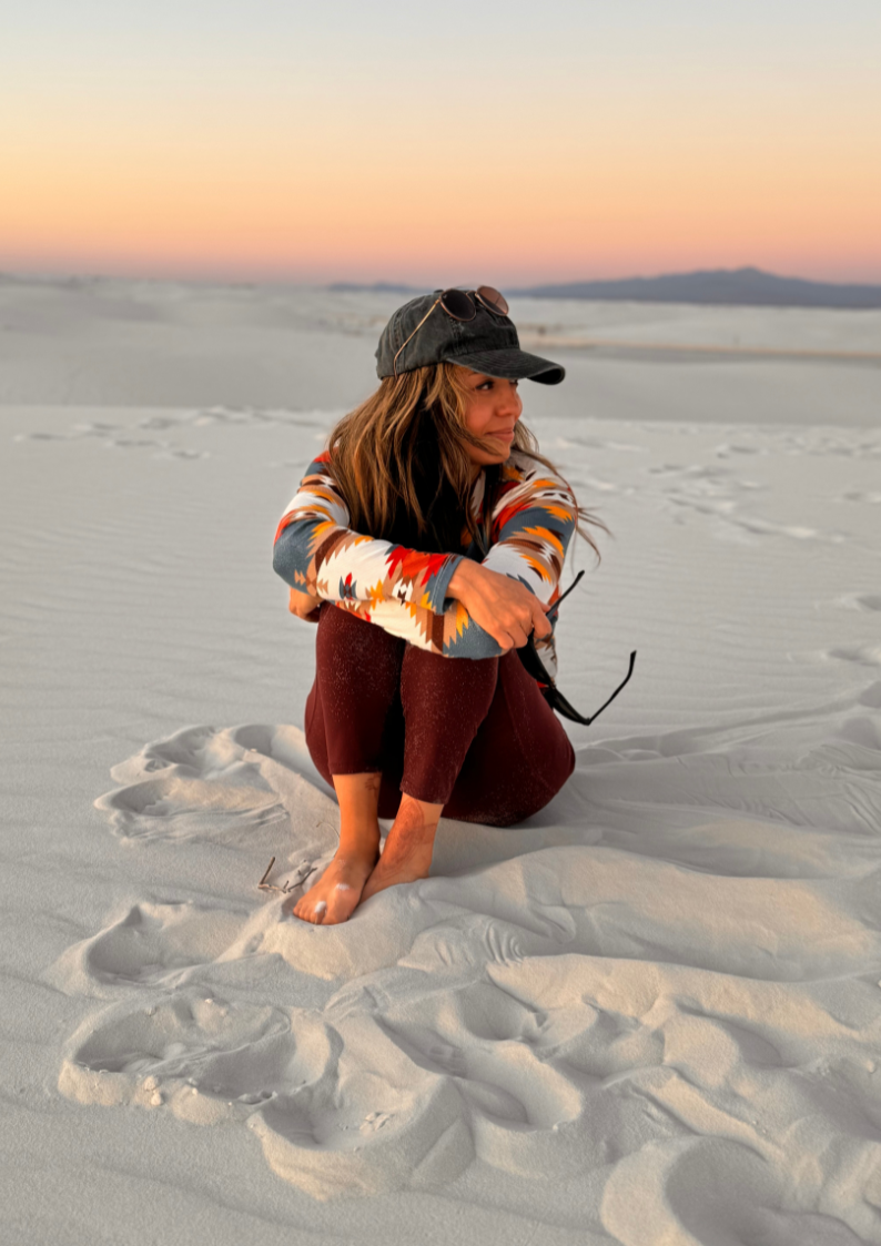 founder.jpg Samantha Matta, founder of Nuevo Om, seated on the white sand at sunset.