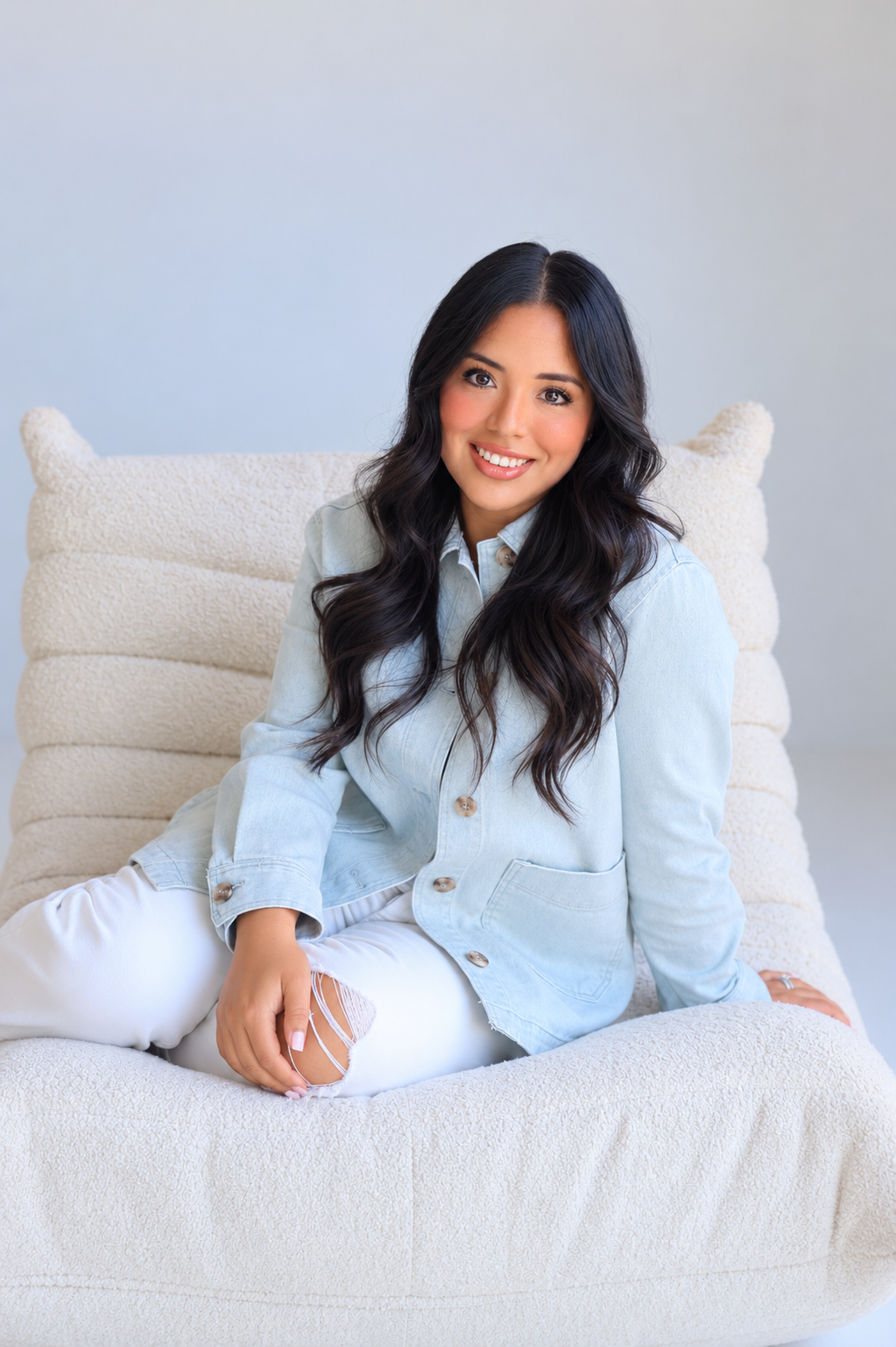 Shannon Ortiz, host of the Before You Go Podcast, seated for a portrait photo.