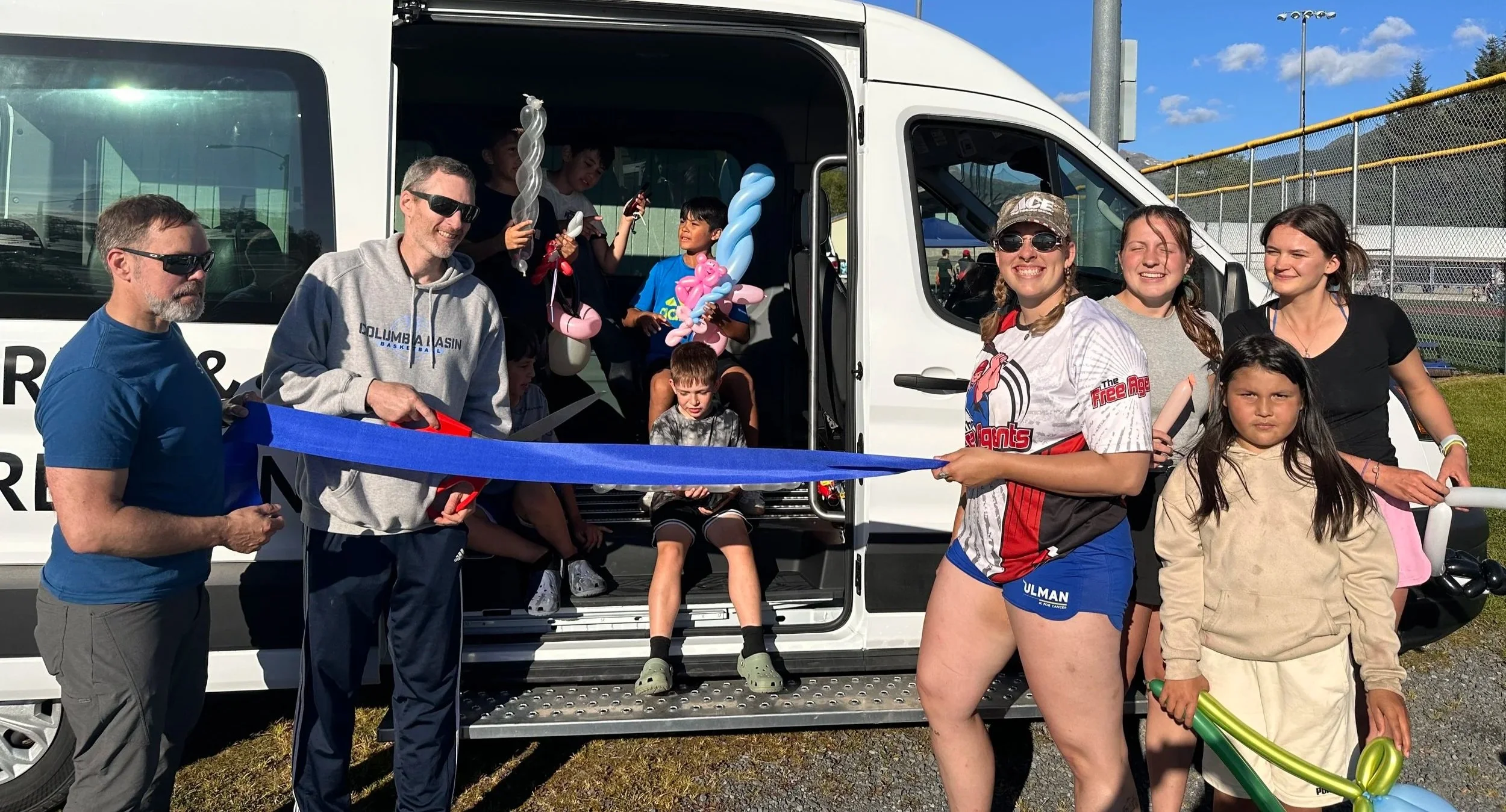 Adults and youth cutting the ribbon to Sitka's new transit van funded by the Sitka Recreation Foundation.