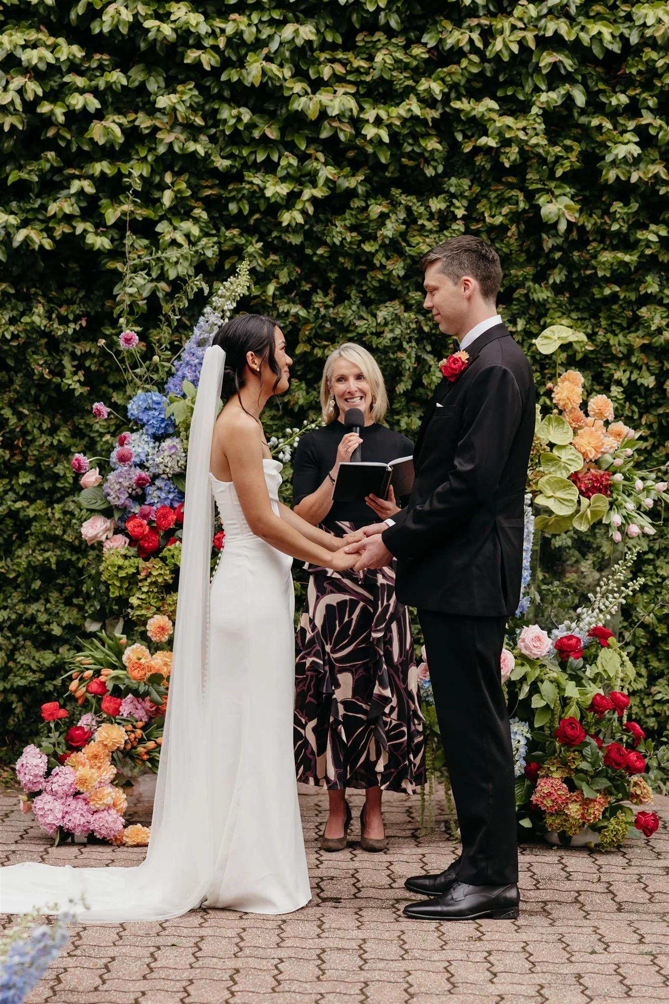 A celebrant leading a garden wedding ceremony melbourne