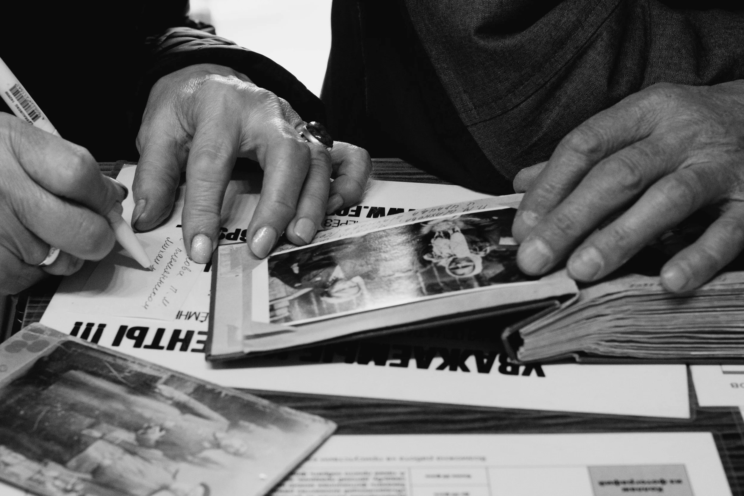 Close-up of treasured family photographs shared as part of a meaningful life story session