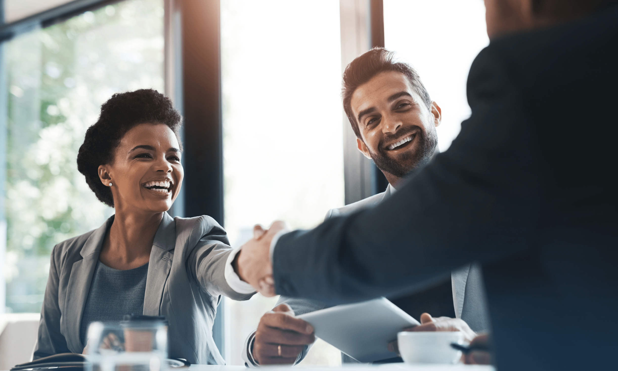 Happy business people shaking hands