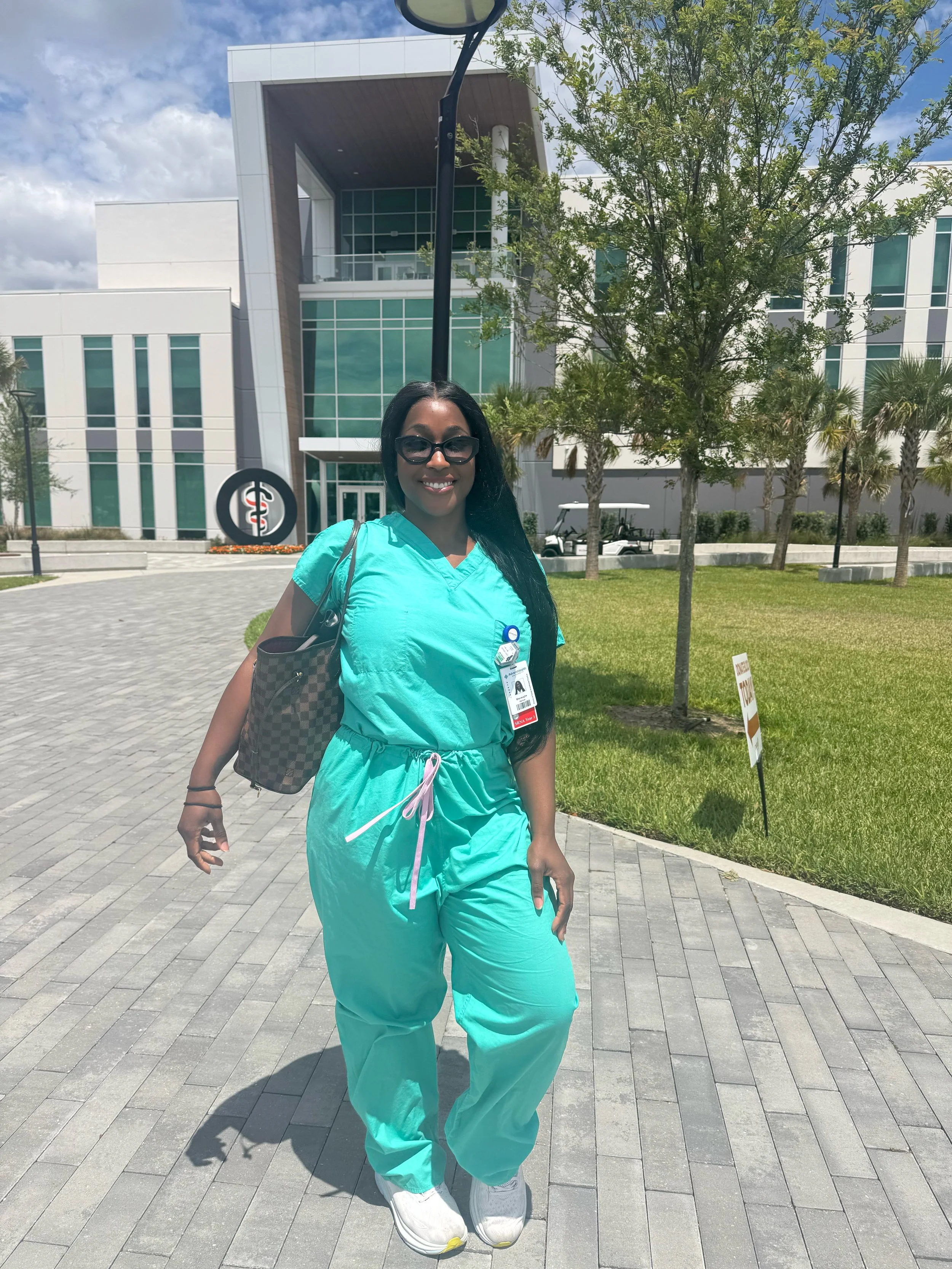 Shevaughn Shay, SRNA and founder of Anesthesia Aesthetics, outside a clinical facility — inspiring ICU nurses to pursue CRNA school