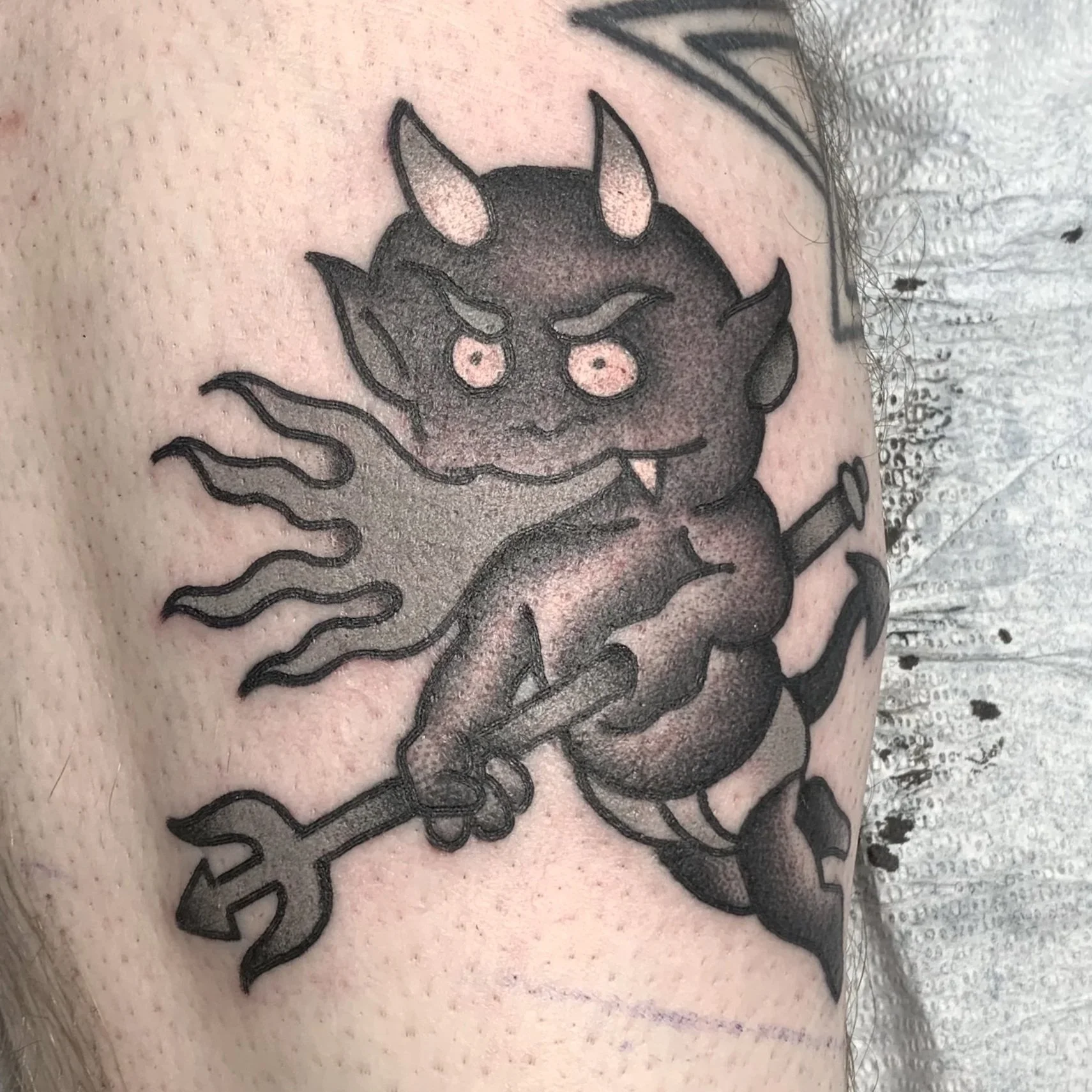 Traditional black and gray Hot Stuff tattoo