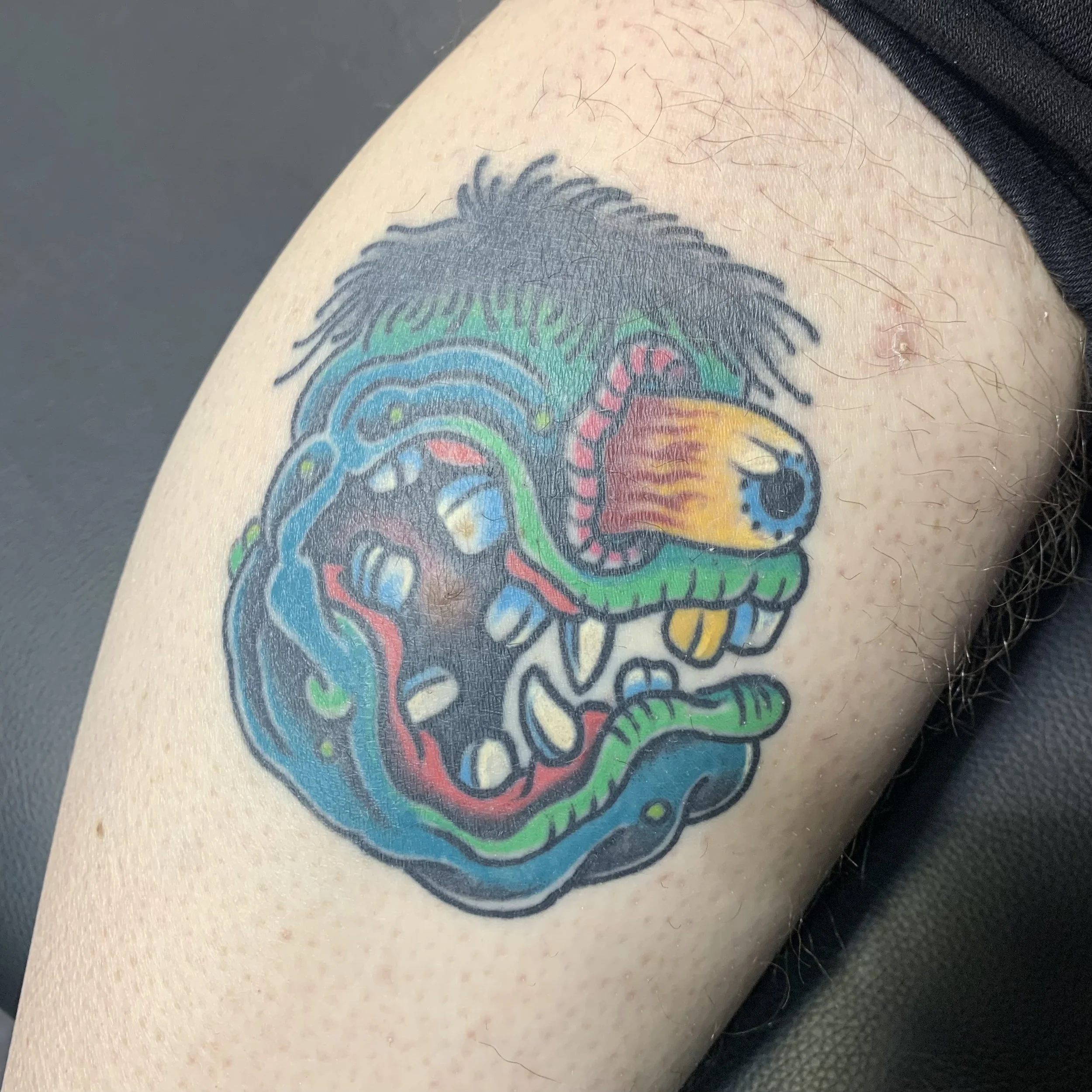 Healed traditional tattoo inspired by an Ed Roth design
